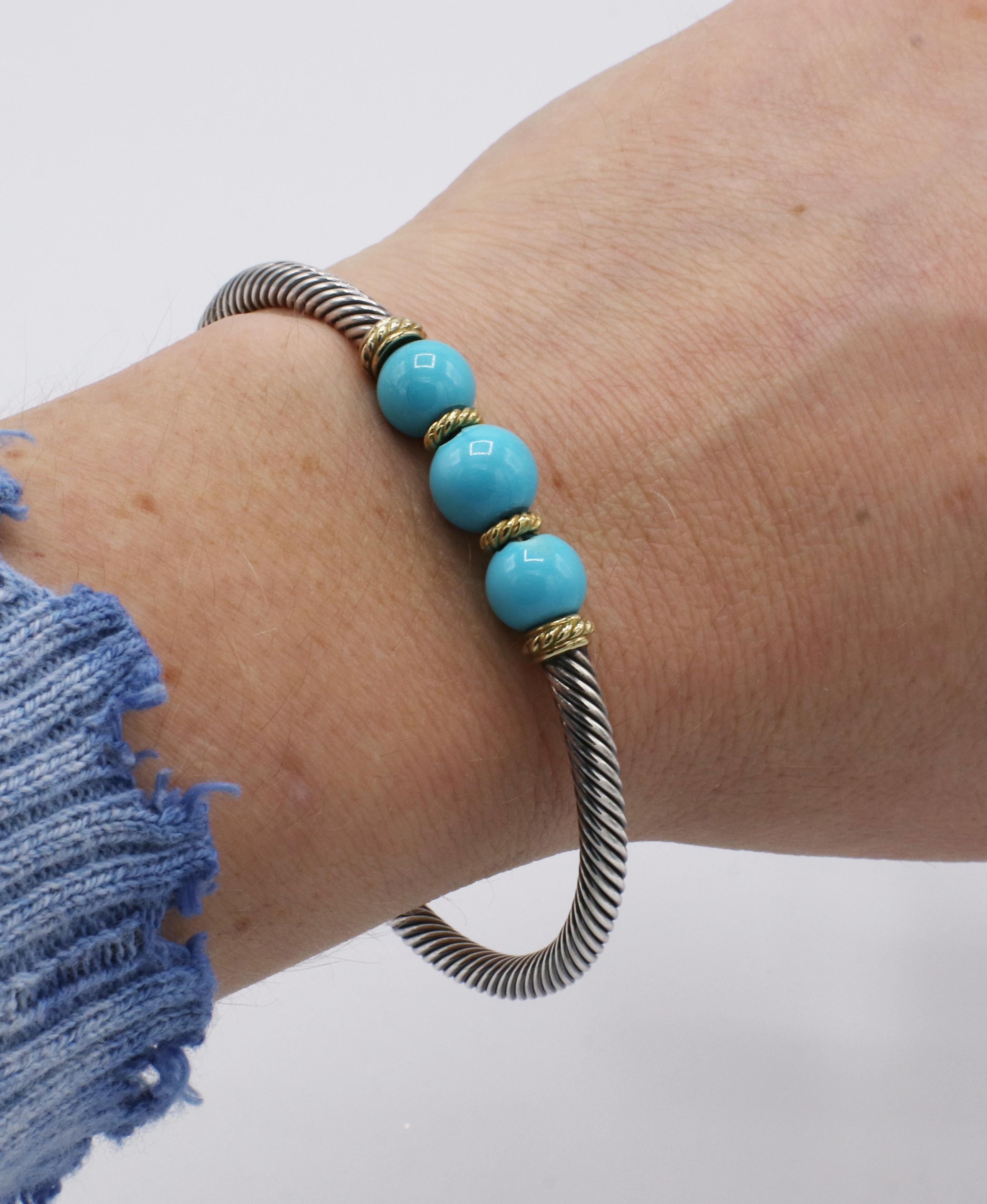 David Yurman Cable Sterling Silver & Gold Turquoise Bead Bracelet *Note* Beads chipped, sold AS IS
Metal: Sterling silver & 18k yellow gold
Weight: 19 grams
Cable width: 3.5mm
Turquoise: 8-9mm beads, chips on the sides
Circumference: Approx.