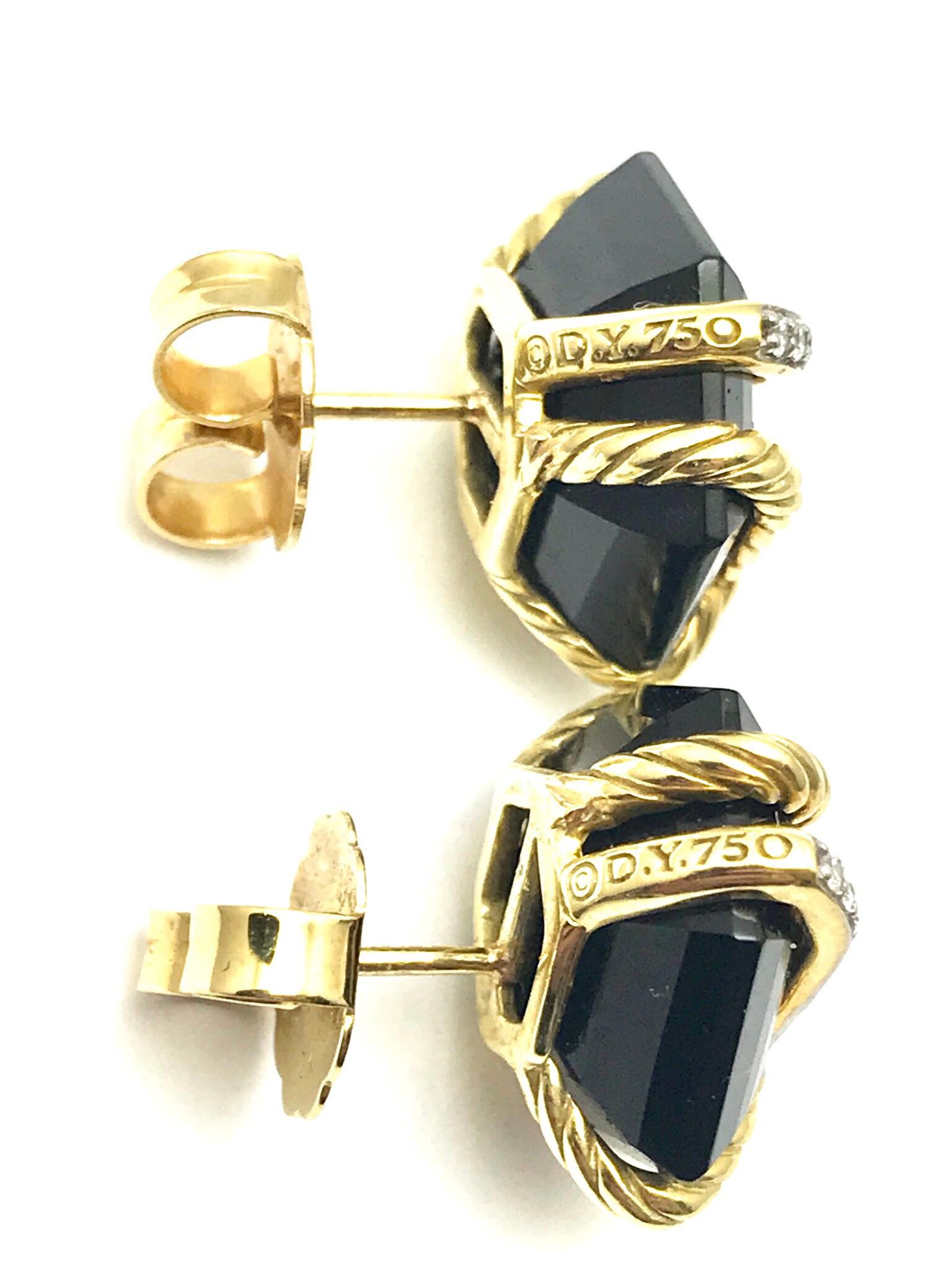 David Yurman cable wrap earrings with black onyx and diamonds in 18 karat yellow gold.  There is 0.06 carats in diamonds, and the onyx is 10.00 x 10.00mm.  The Cable Wrap Collection highlights David Yurman’s strength as an innovator, creating