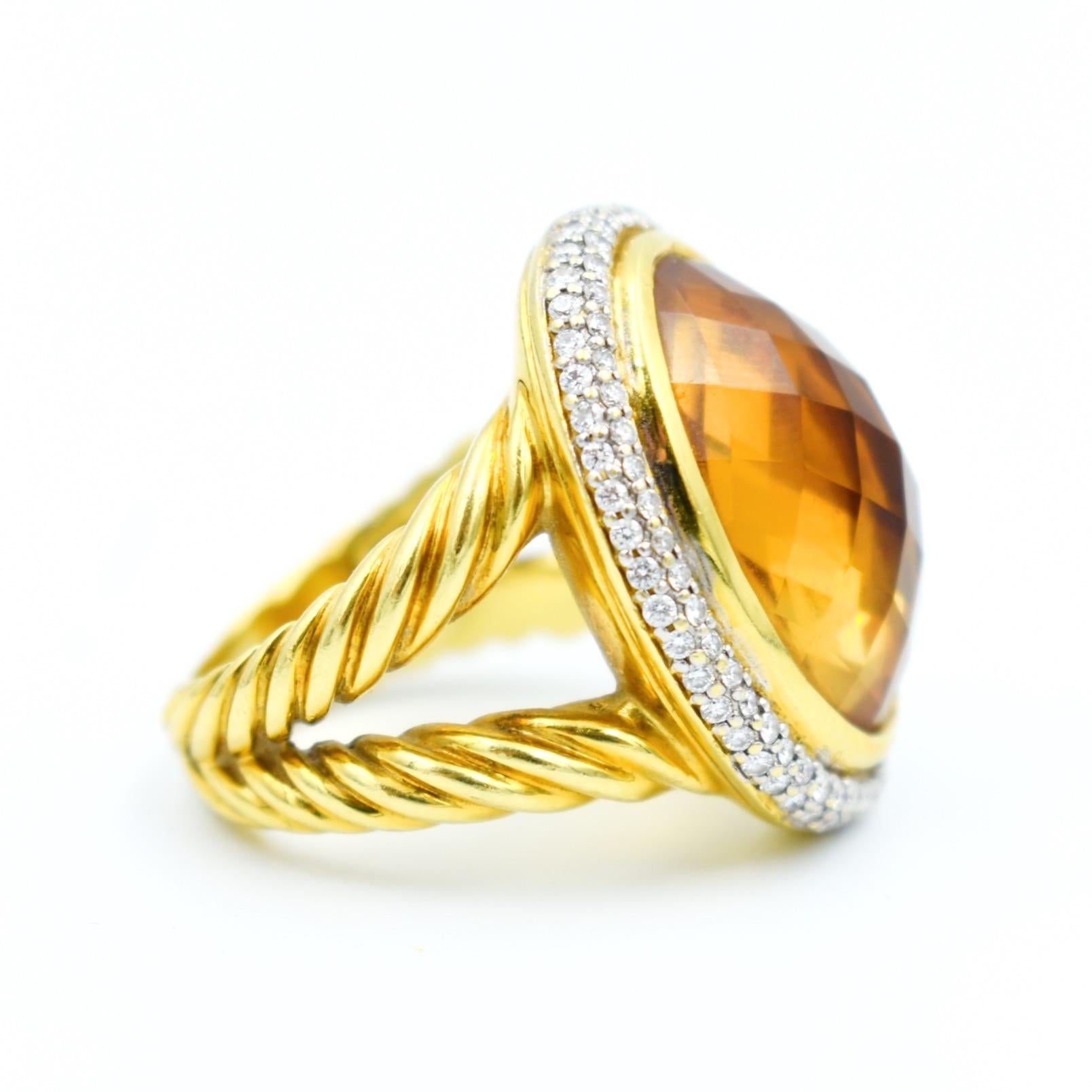 Vintage cocktail ring by jeweler David Yurman in 18k yellow gold. It features a checker-cut champagne topaz weighing approximately 12.5 carats (18.0 x 13.0 x 8.0 mm) in a double surround of brilliant-cut diamonds weighing approximately 1 carat in