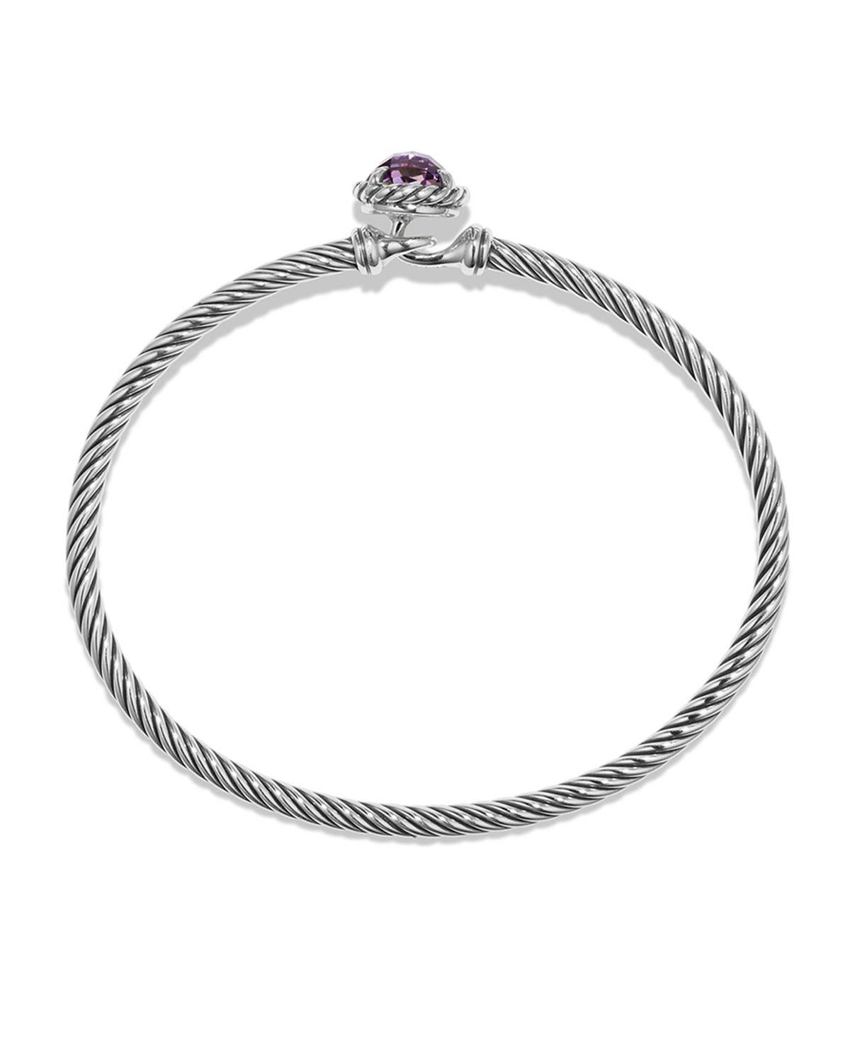 Touch of style, value, and greatness, this David Yurman Cable Buckle Bracelet is made with Sterling silver and 14 karat yellow gold accent plating in twisted cable design and it features faceted peridot. It weighs 29.8 grams and it is 5mm wide to