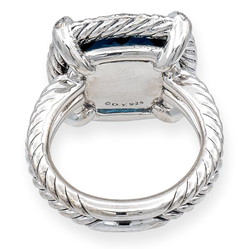 David Yurman ring from the Chatelaine collection finely crafted in sterling silver featuring a Hampton Blue Topaz weighing 12.80 carats (14mm) in the center surrounded by a halo of pave set diamonds weighing 0.29 carats total weight. Double row