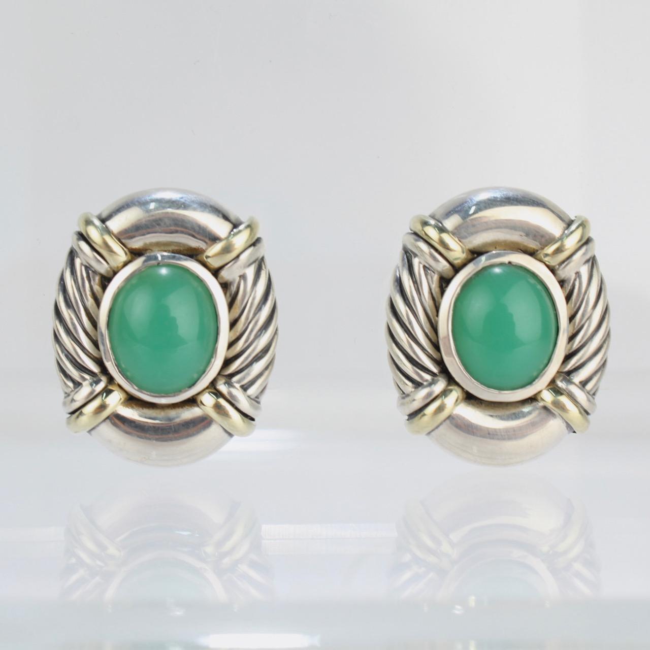 A fine pair of David Yurman clip-on earrings.

Each set with a central chrysoprase cabochon in an oval sterling mount, the edges highlighted with cable decoration and 18K gold accent bands.

Originally, the earrings were made as omega clips, and