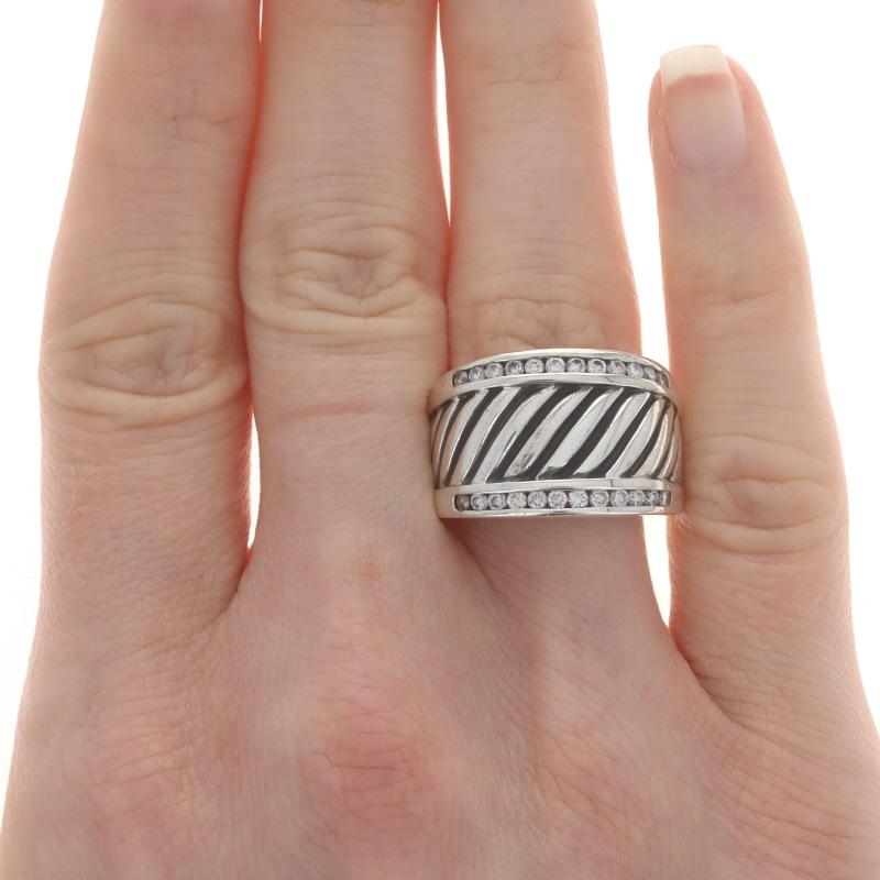 Size: 7 3/4
Sizing Fee: Up 1/2 a size for $25 or Down 1/2 a size for $25

Brand: David Yurman
Design: Cigar Band

Metal Content: Sterling Silver

Stone Information
Natural Diamonds
Carat(s): .50ctw
Cut: Round Brilliant

Total Carats: