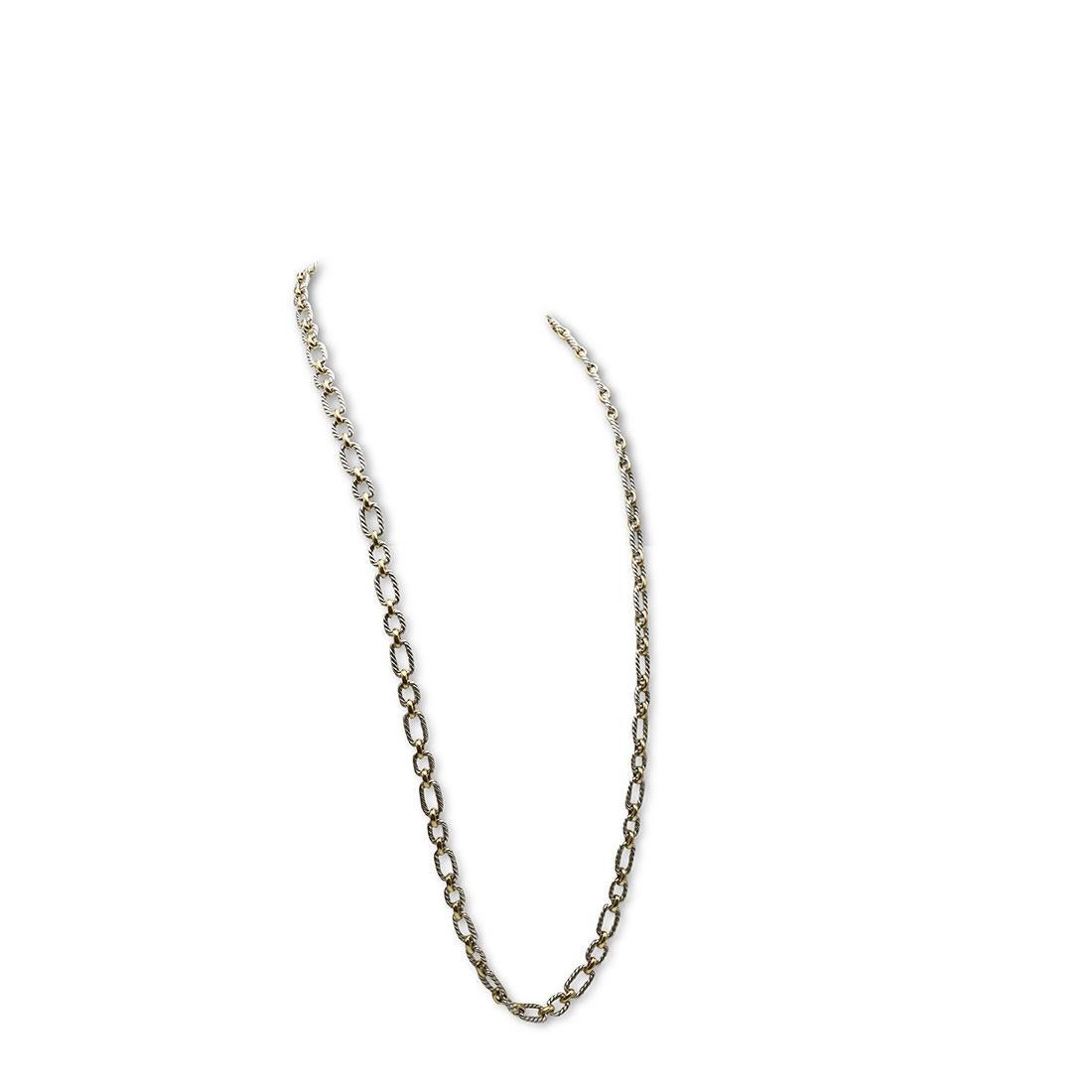 Authentic David Yurman cushion link necklace crafted in sterling silver and 18 karat bonded yellow gold. The necklace is comprised of oval links inspired by David Yurman's classic cable design. Features hidden blue sapphires on each end of the