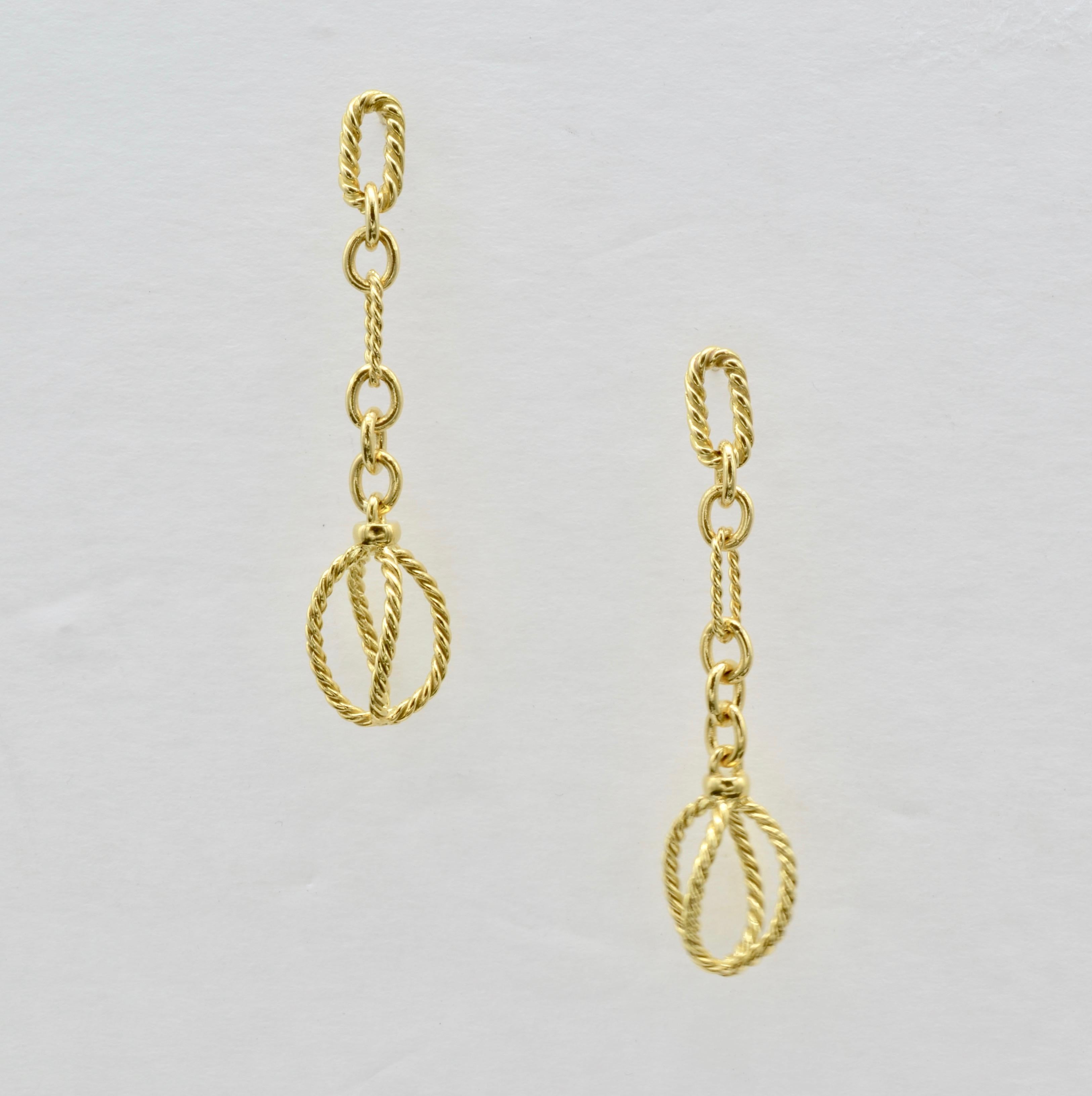 Dangling twisted chains of solid gold 18K yellow gold hang with a cage-like bearing on the bottom. Alternating textures of high polished loops create an elegant look that can easily be dressed up or dressed down. A high fashion staple for every