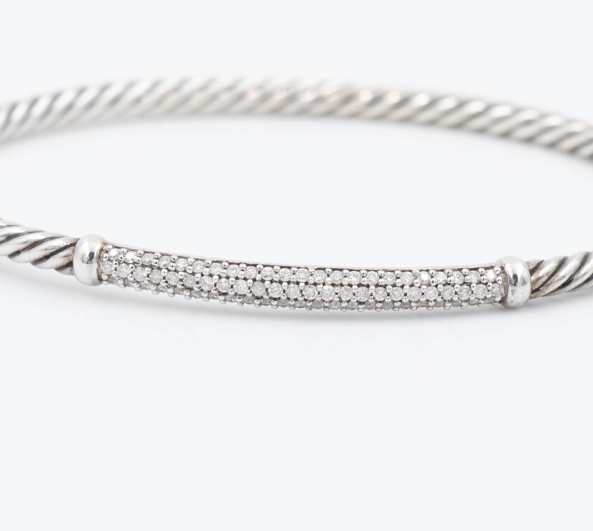 This beautiful David Yurman bracelet has diamonds set on the silver bar atop the cable wrap cuff bracelet design.  The width of the bracelet cable wrap is 3mm and features a hinge clasp.  This is a great bracelet to stack with other designs or