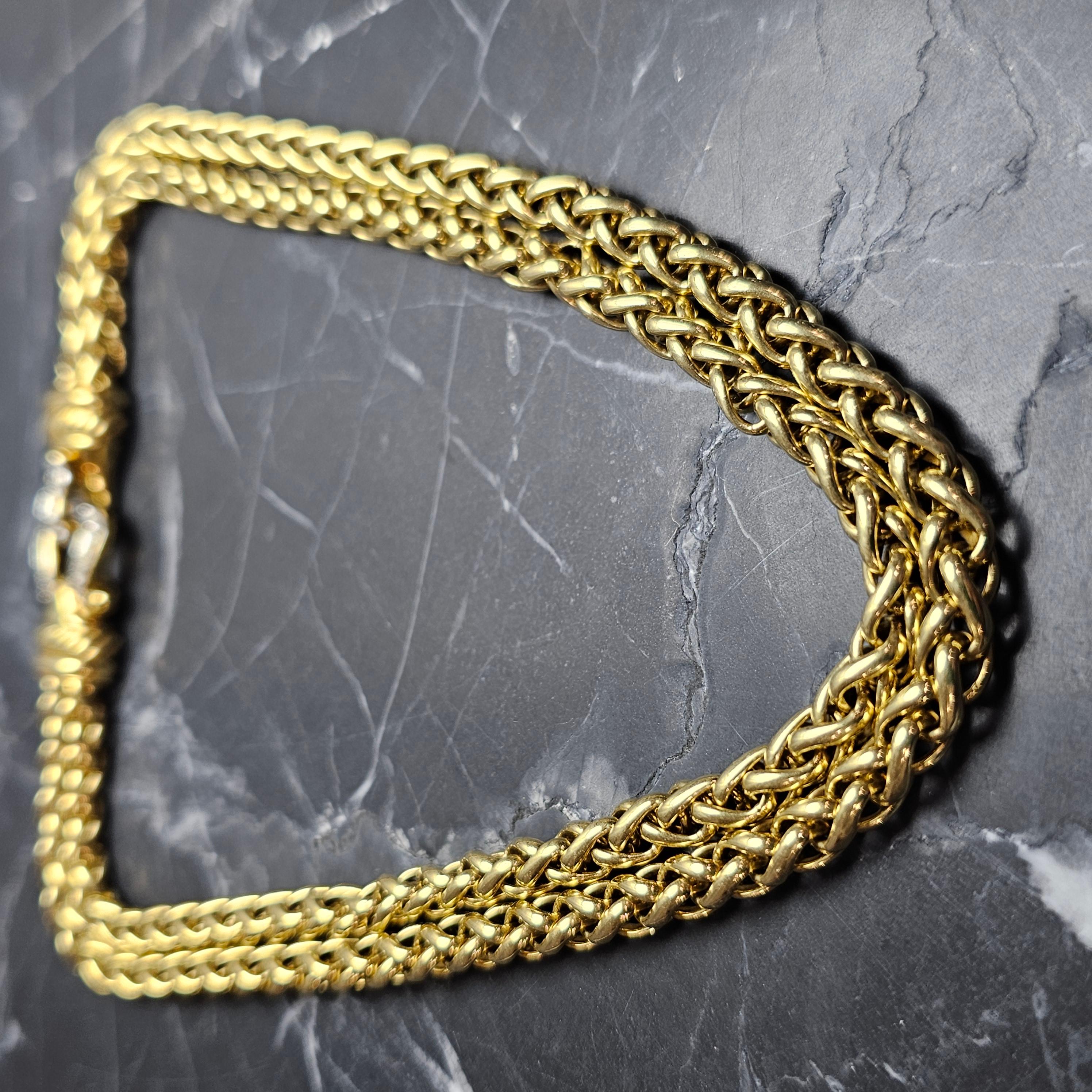 This exquisite David Yurman necklace is a true gem. Crafted from 18k yellow gold, it features a double wheat chain design with a sparkling diamond buckle. The necklace is perfect for any occasion and is sure to make a statement. The brand is known