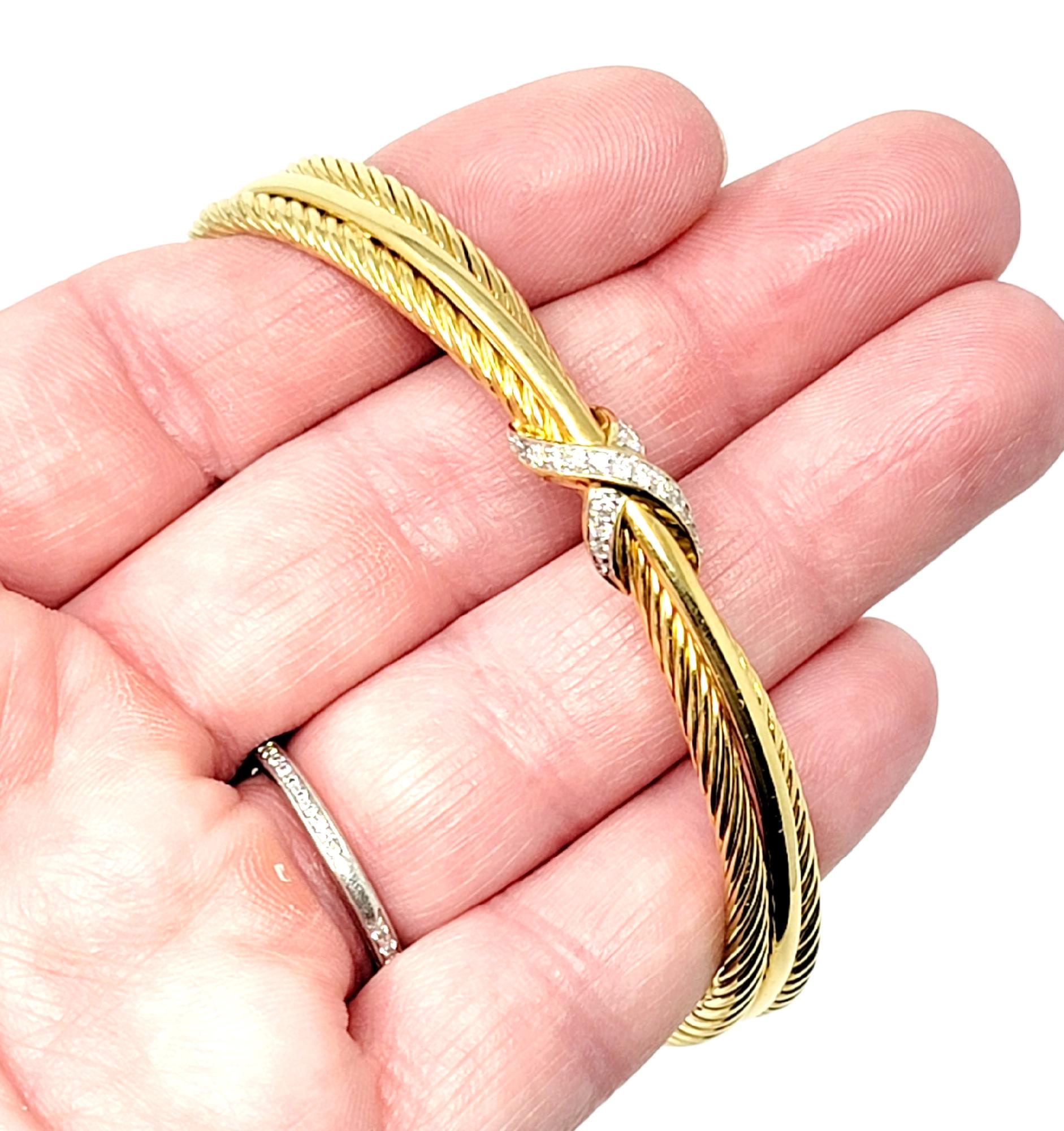 Beautiful modern cuff bracelet by famed designer, David Yurman. This lovely piece can be stacked with other bracelets or worn simply on its own for a touch of understated elegance. The bracelet is made of polished 18 karat yellow gold and features
