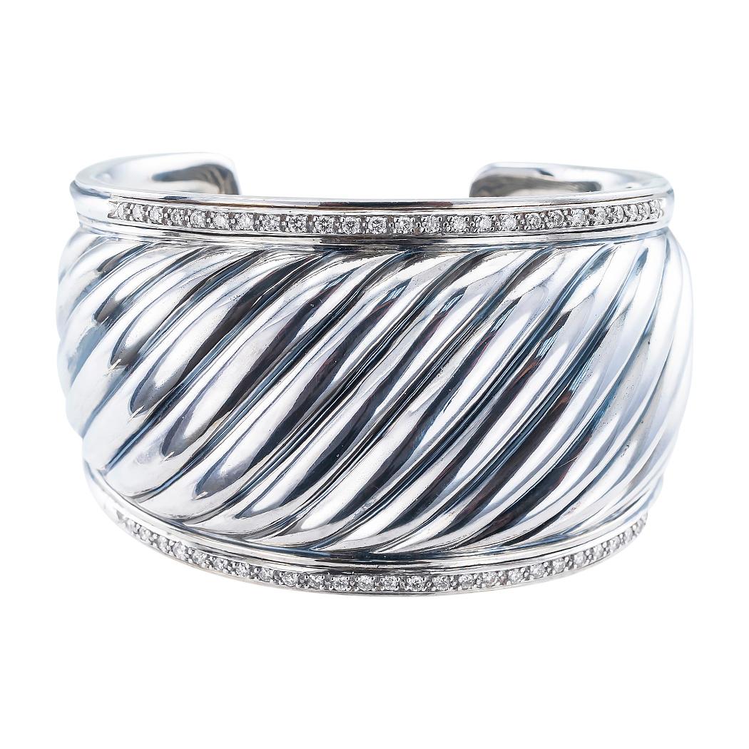 David Yurman diamond and sterling silver fluted cuff bracelet.

DETAILS:

DIAMONDS:  fifty round brilliant-cut diamonds totaling approximately 0.75 carat.

METAL:  sterling silver applied with highlight oxidation.

WEIGHT:  69.4 grams.

HALLMARKS: 
