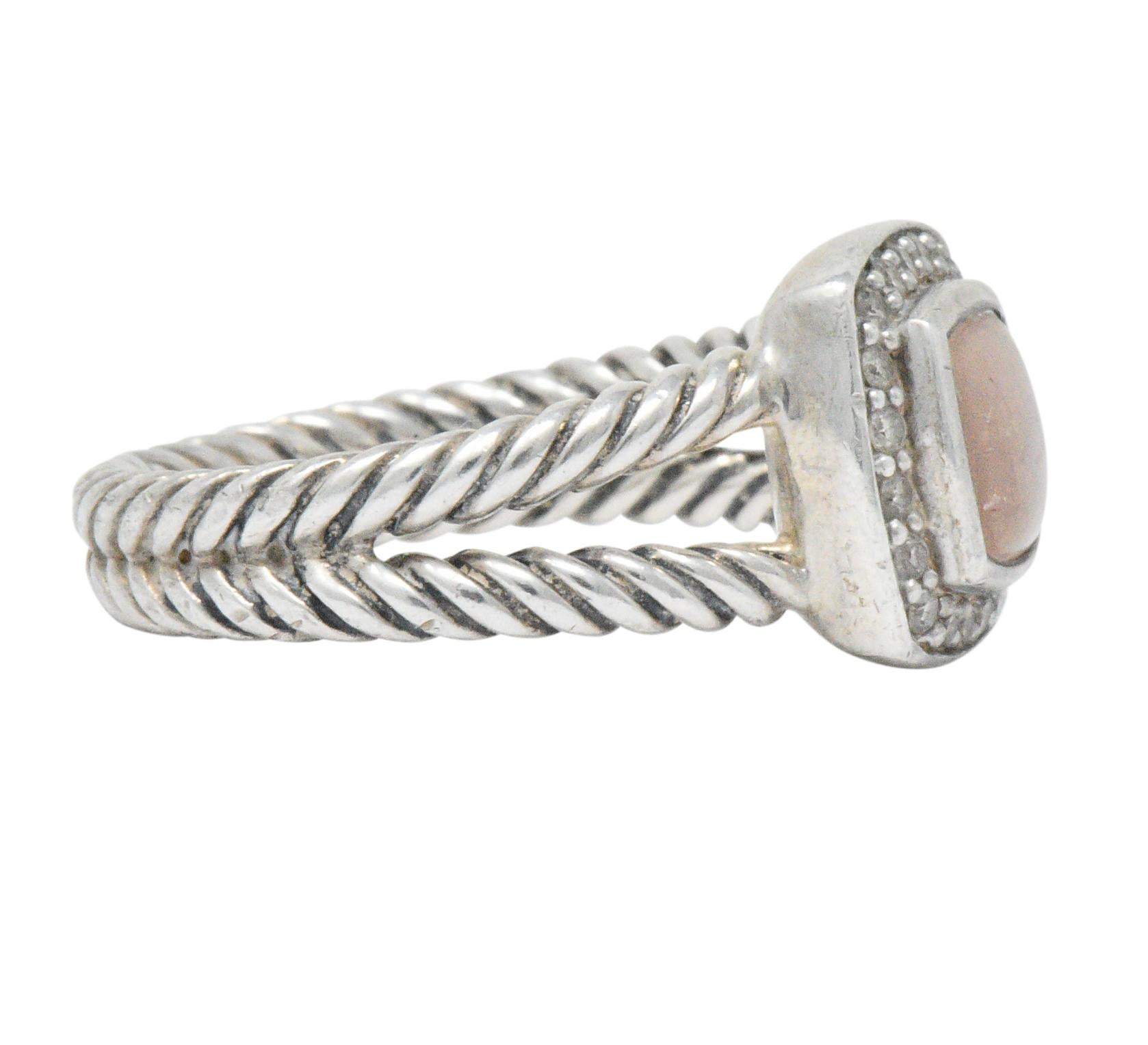 Centering a cushion shaped crystal-topped pink mother of pearl

Bezel set and surrounded by diamonds weighing approximately 0.17 carats total, eye-clean and white

Cable twist silver split shank

From Albion collection

Signed DY for David