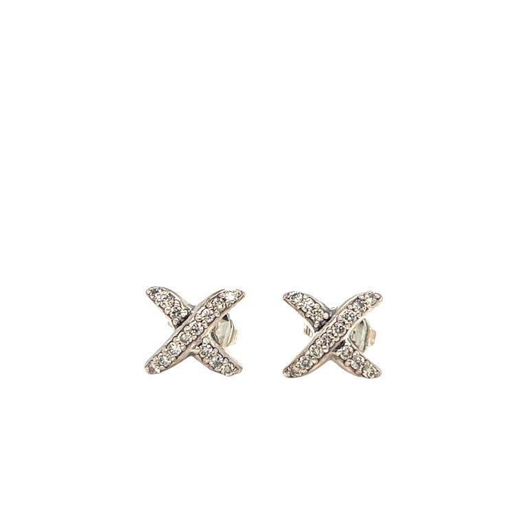 This is a lovely pair of authentic earrings by David Yurman. It is crafted in sterling silver and features a classic yet contemporary X design, decorated with approximately 0.28 carat of colorless diamond. The earrings are hallmarked 925