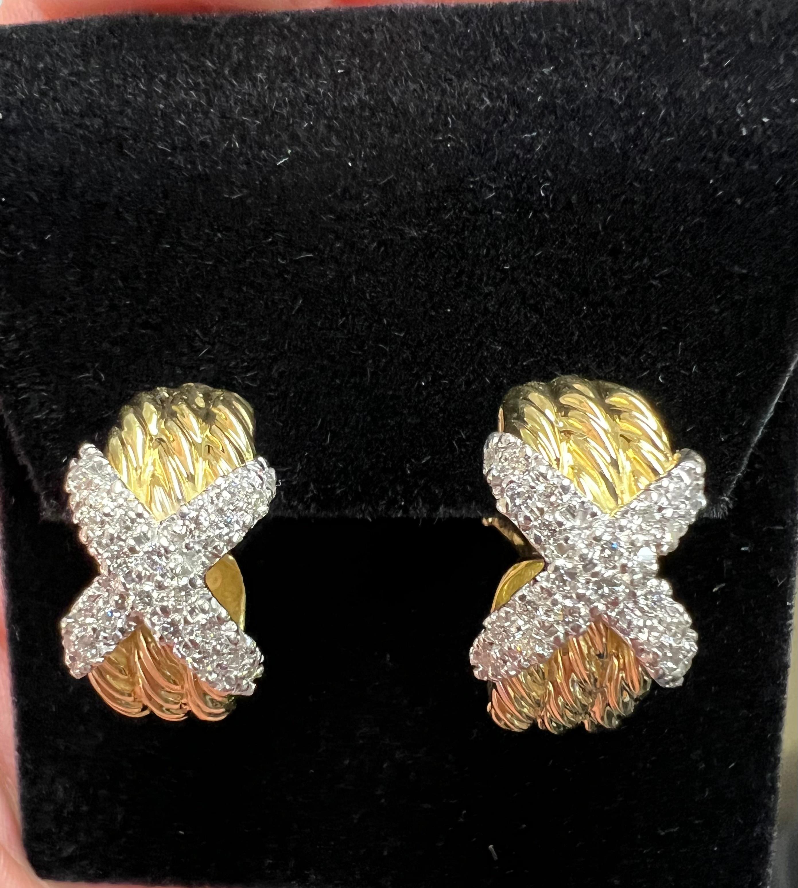 David Yurman diamond X 18k yellow gold hoop earrings.

David Yurman Diamond 18k Yellow Gold Hoop Earrings are a stunning example of luxury jewelry that combines timeless elegance with modern style. Crafted from 18k yellow gold and adorned with