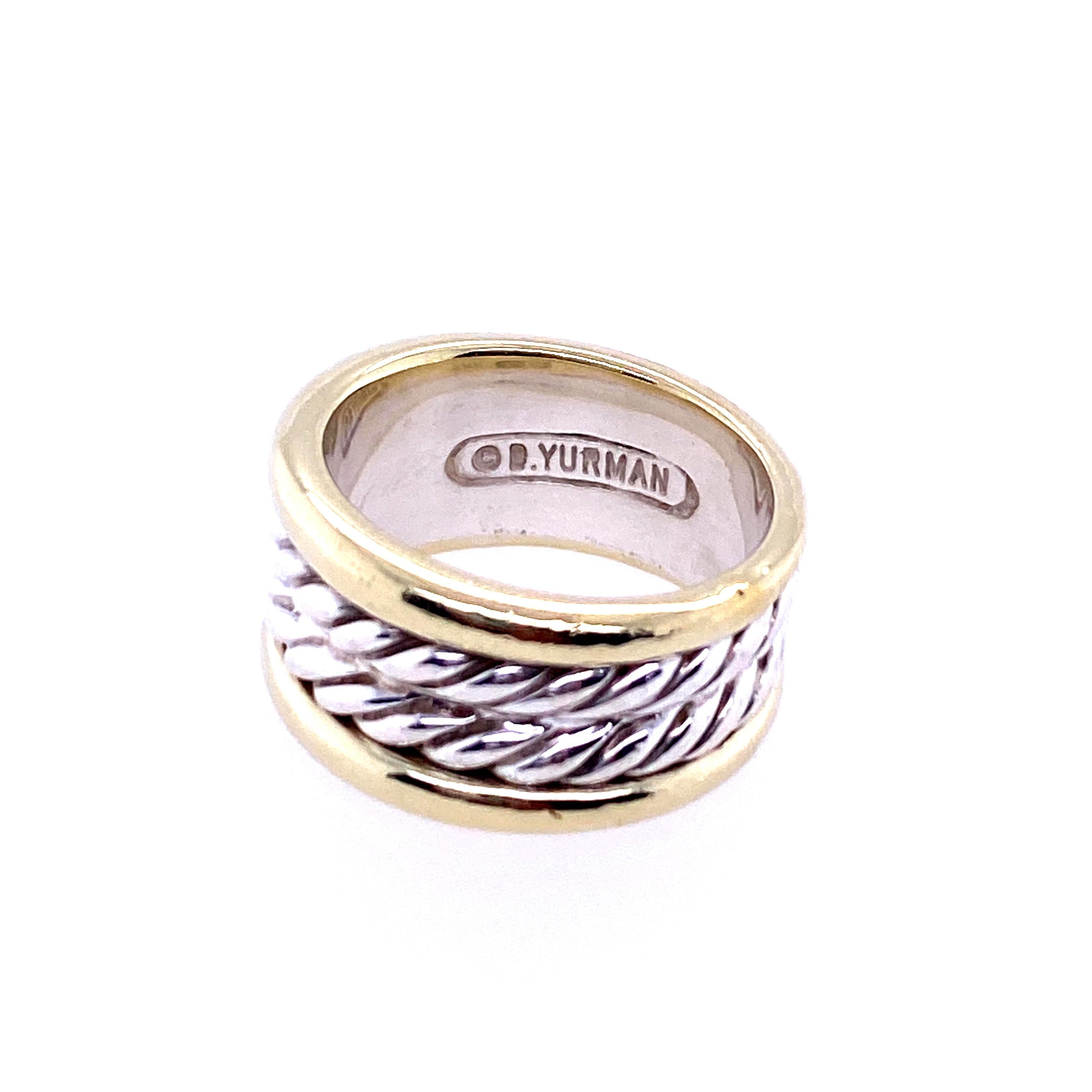 One sterling silver and 14 karat yellow gold ring (stamped 585 925 5.5m D. YURMAN) with a sterling silver double cable center and 14 karat yellow gold outer edges.  The ring measures 10.3mm wide and is a finger size 5.5.