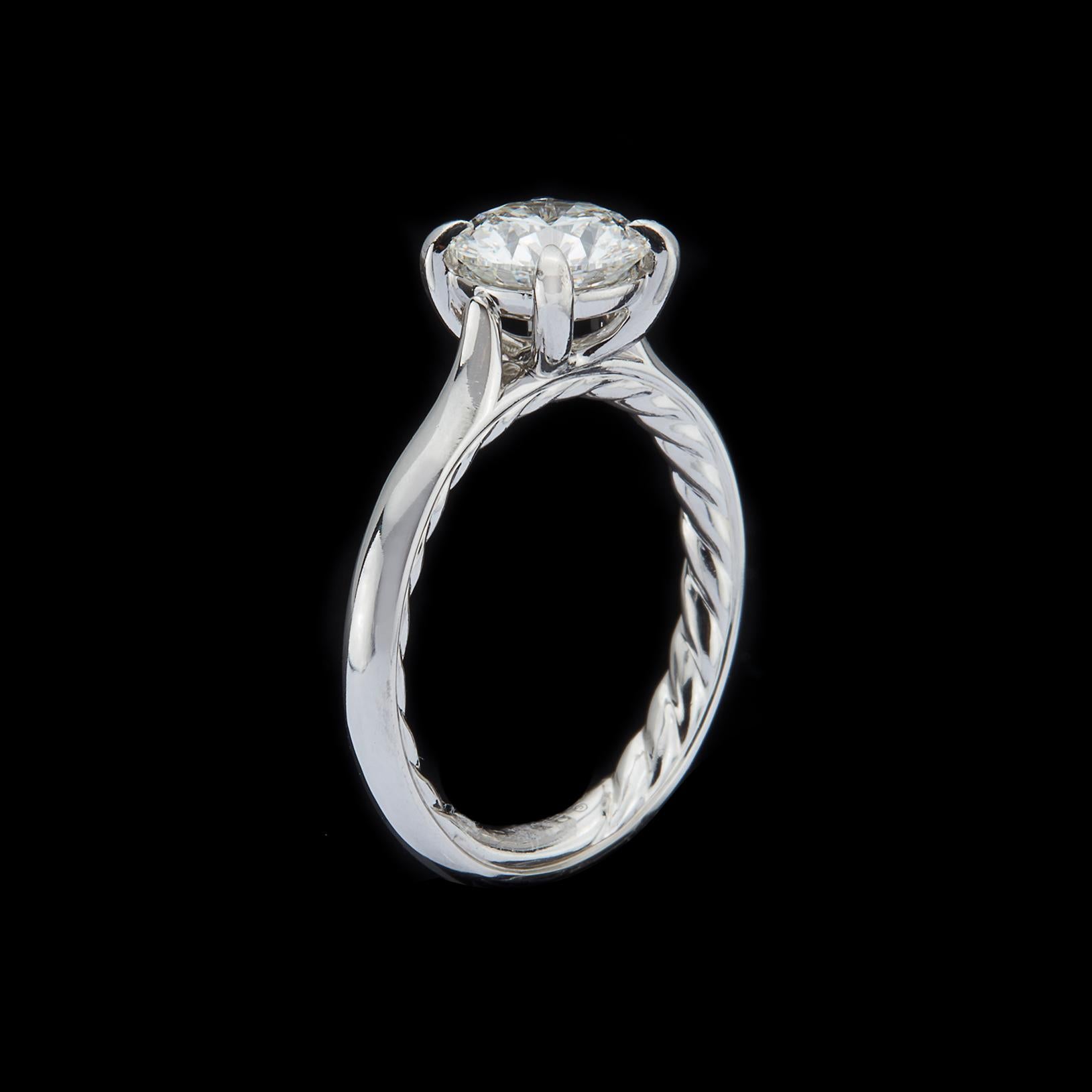 A beautiful 'twist' on a classic design, this platinum David Yurman engagement ring is elegant and contemporary. Centering the finest of diamonds, a 1.43-ct. GIA round brilliant-cut, G/VS1, set in 4-prongs with the inner Cable motif. The ring weighs