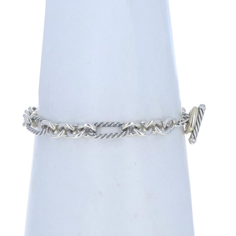 Brand: David Yurman

Metal Content: Sterling Silver & 18k Yellow Gold

Chain Style: Figaro
Bracelet Style: Chain
Fastening Type: Toggle Clasp
Features: Cable Detailing

Measurements

Length: 7 1/4