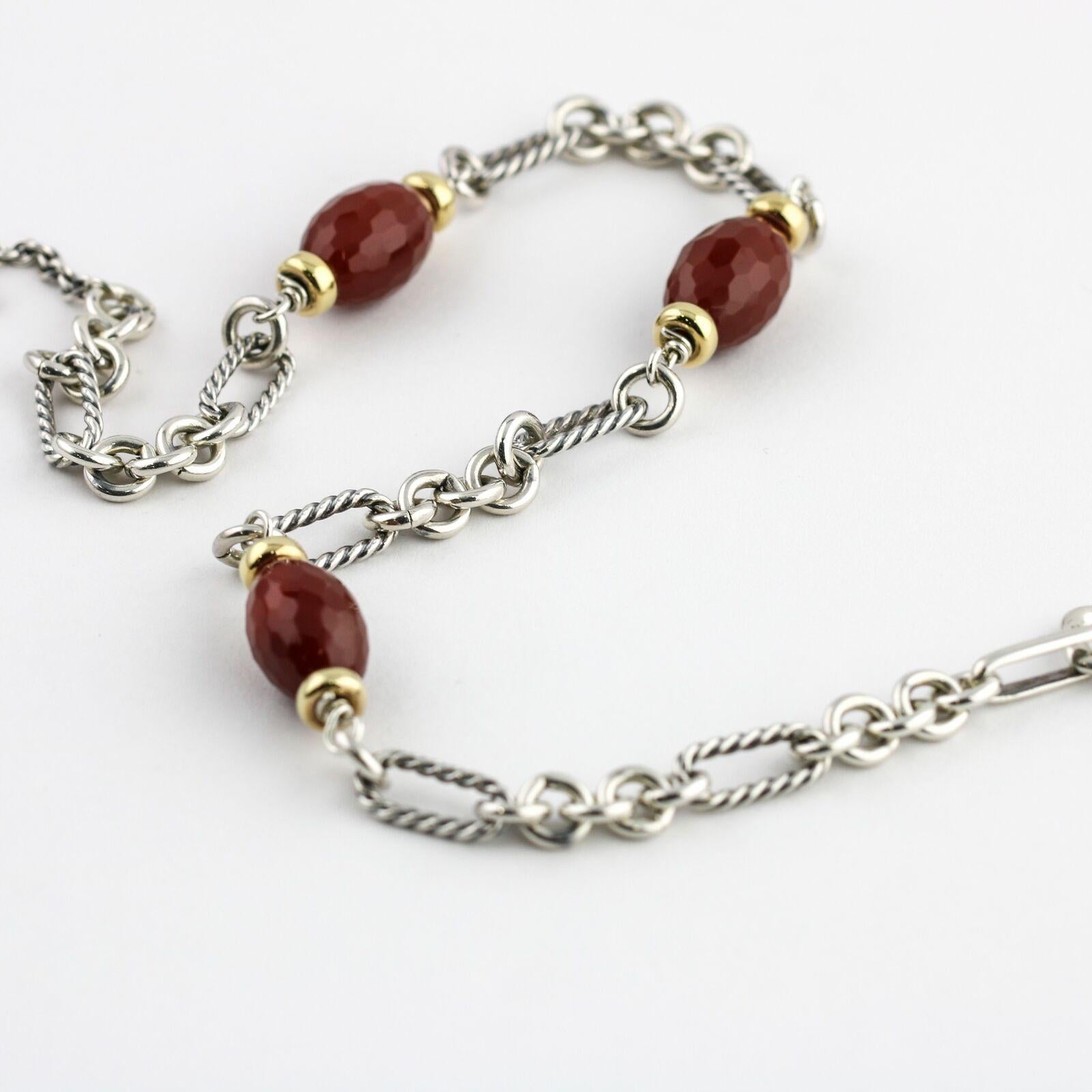 David Yurman Bijoux choker necklace in sterling silver and 18-karat yellow gold. The necklace features Yurman's signature Figaro link with faceted Carnelian gemstones and yellow gold beads. Toggle clasp.  

Length, 15.5 inches
Gemstones, 17mm x
