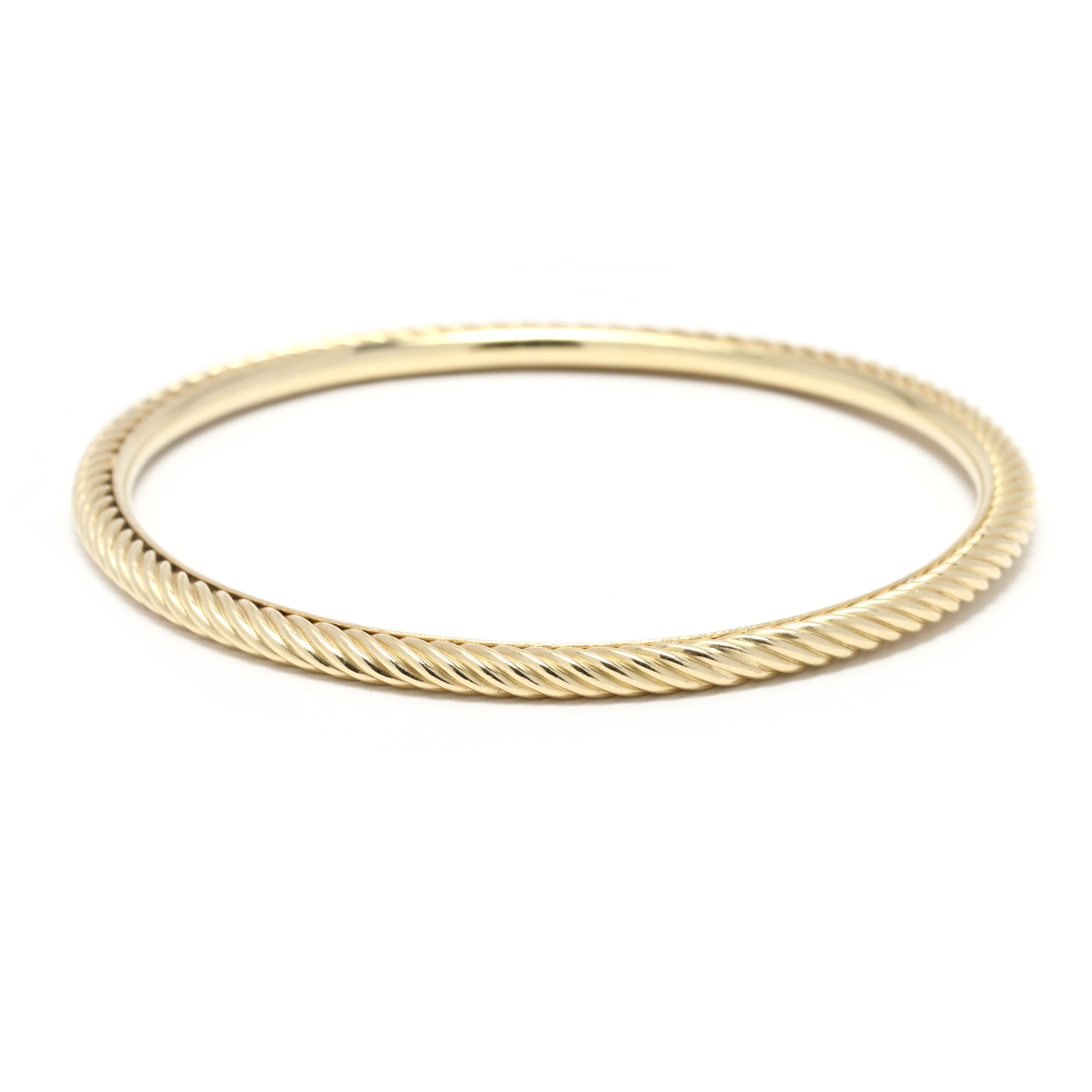 This David Yurman Gold Cable Bangle is a timeless classic! Crafted in 18K yellow gold and measuring 6.5 inches in length, this bangle is the perfect size for a small wrist. Featuring the signature gold cable twist, this bangle is a must-have