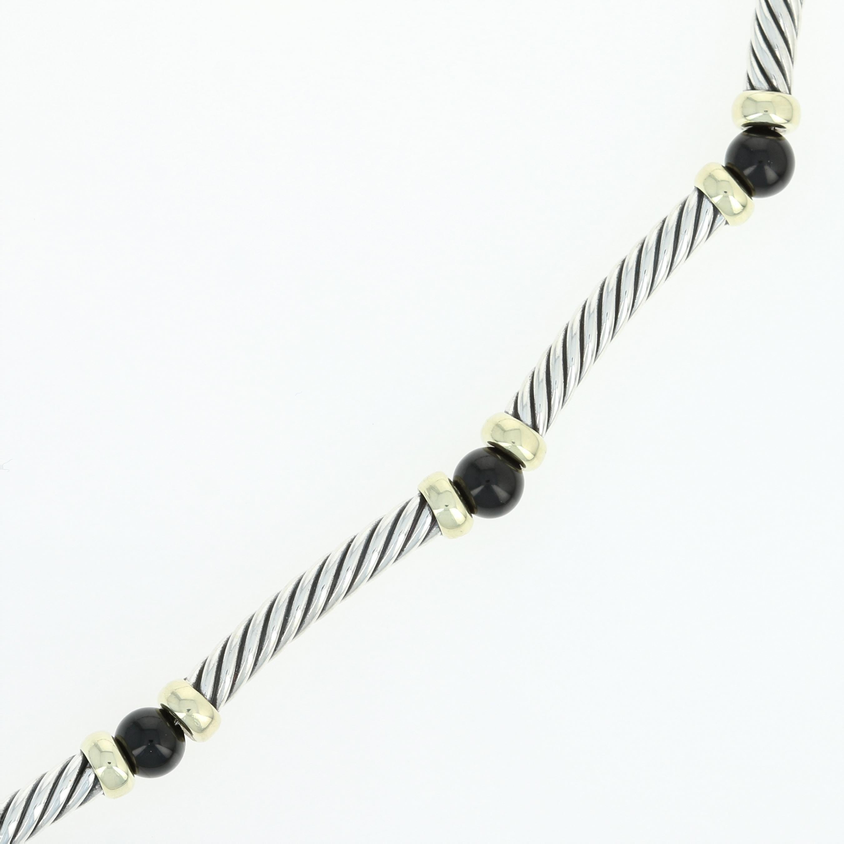 Step out in style with David Yurman! This sophisticated Hampton necklace showcases cable-textured sterling silver tubes that are slightly curved and capped in 14k yellow gold which are beautifully strung with jet black onyx beads along a durable