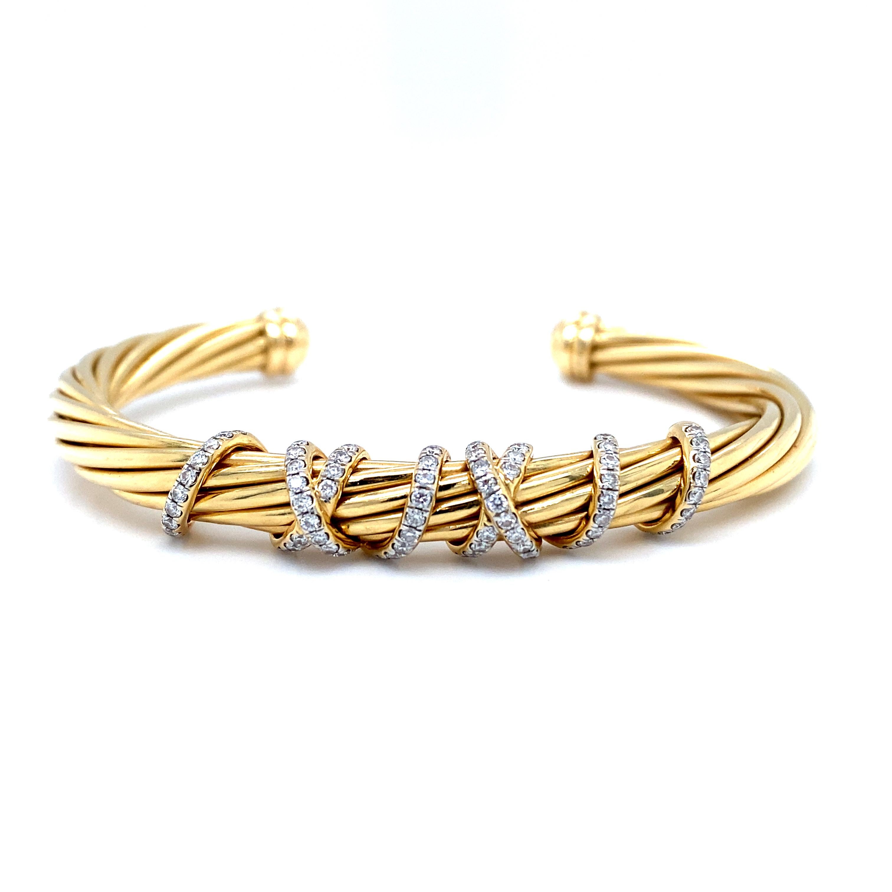 Item Details: This stunning cuff bracelet by David Yurman features a twisted gold design with a wrapping crossover in the center studded with round diamonds. It is impeccably crafted in 18 karat yellow gold and features over half a carat of