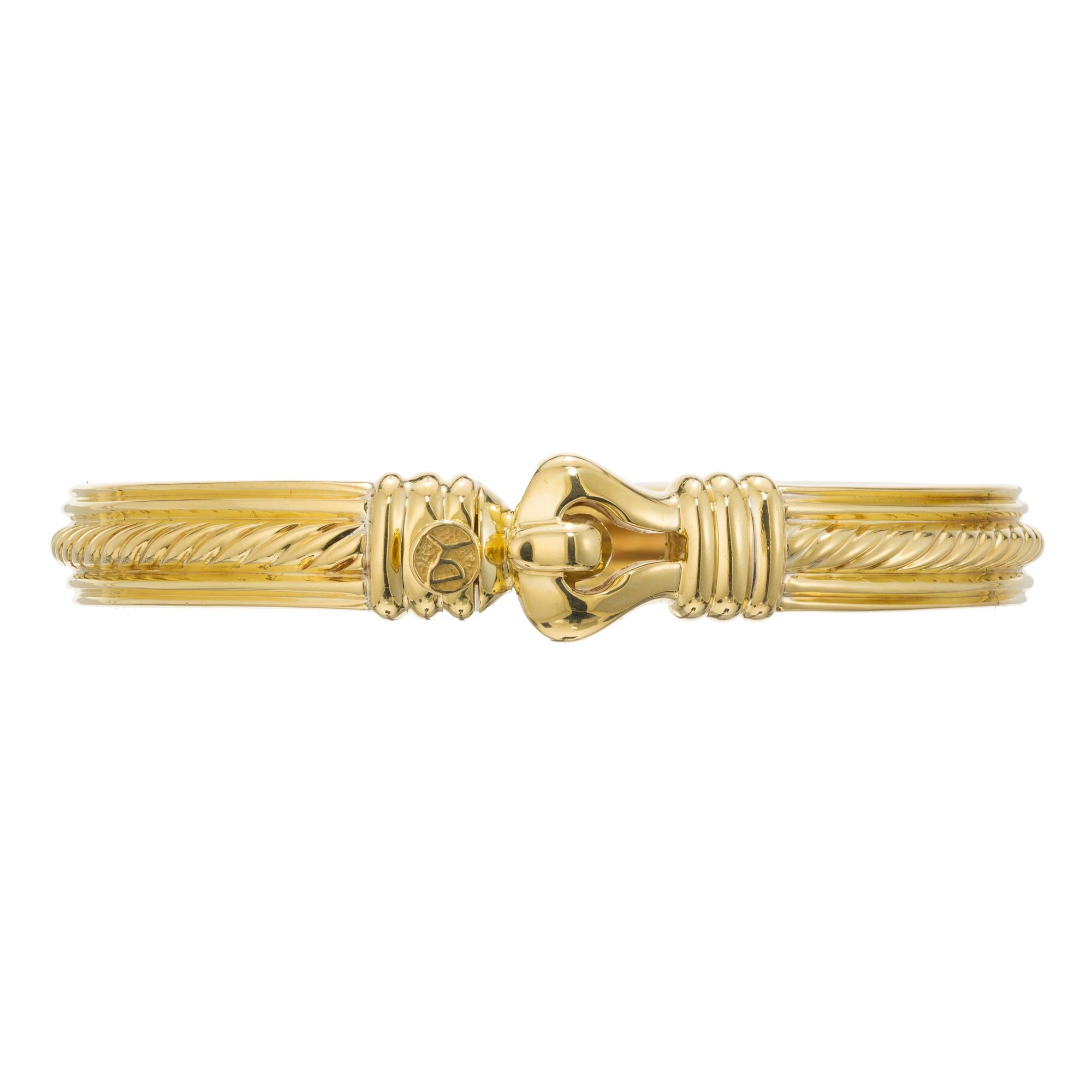 Solid 18k yellow gold Classic David Yruman bangle bracelet, with signature D Y push button on Clasp. Hinged style with cable center.  Fits up to a 7.5 inch wrist. 

46.7 grams 
18k Yellow gold 
Stamped: 18k Tested: 18k 
Hallmark: D Yurman 
Inside