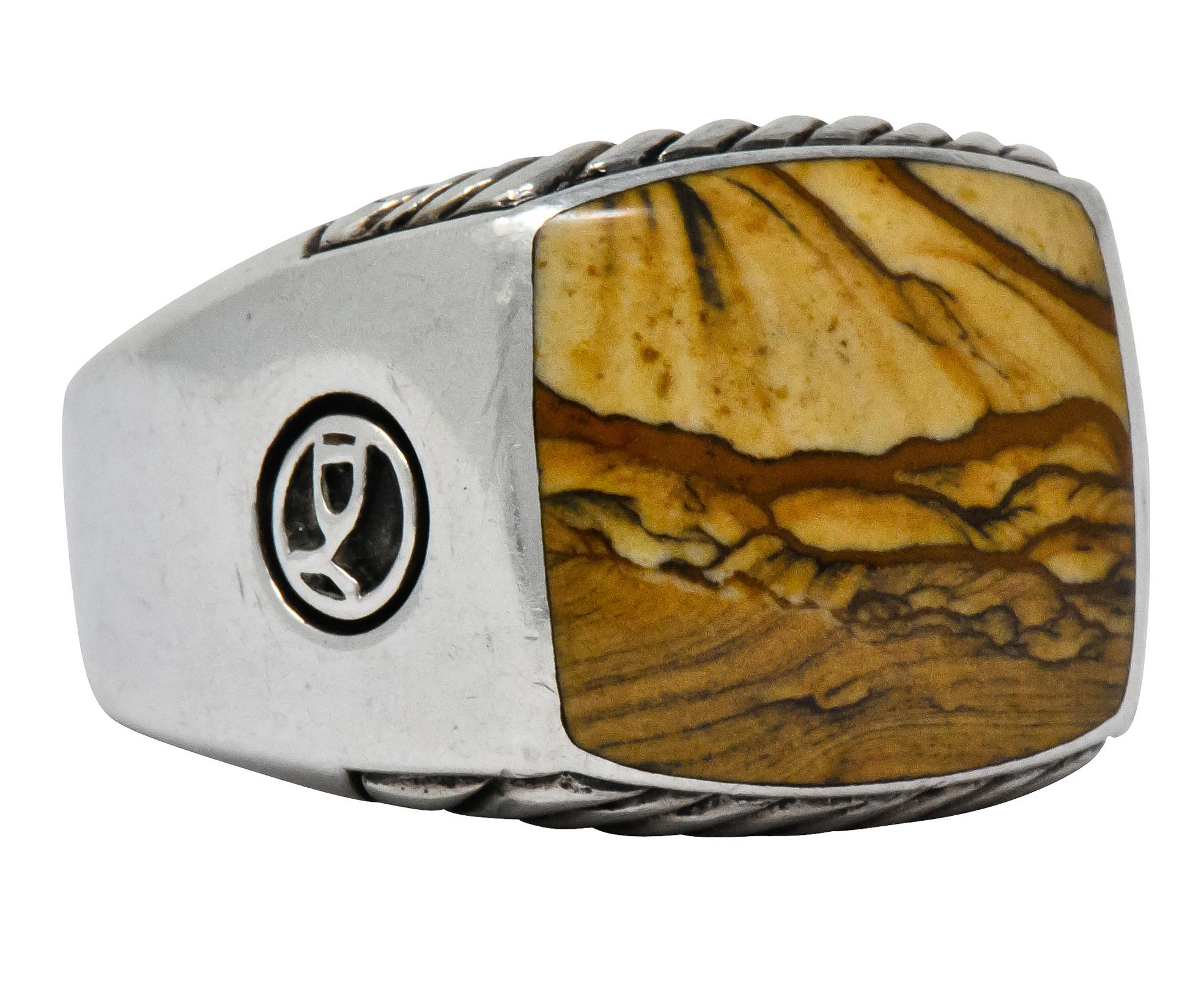 Centering an inlaid square slice of jasper, opaque and yellowish-brown to brown in color with a good polish

Natural jasper pattern presents as a desert landscape

Accompanied by ribbed silver pattern on profile faces

From David Yurman's Exotic