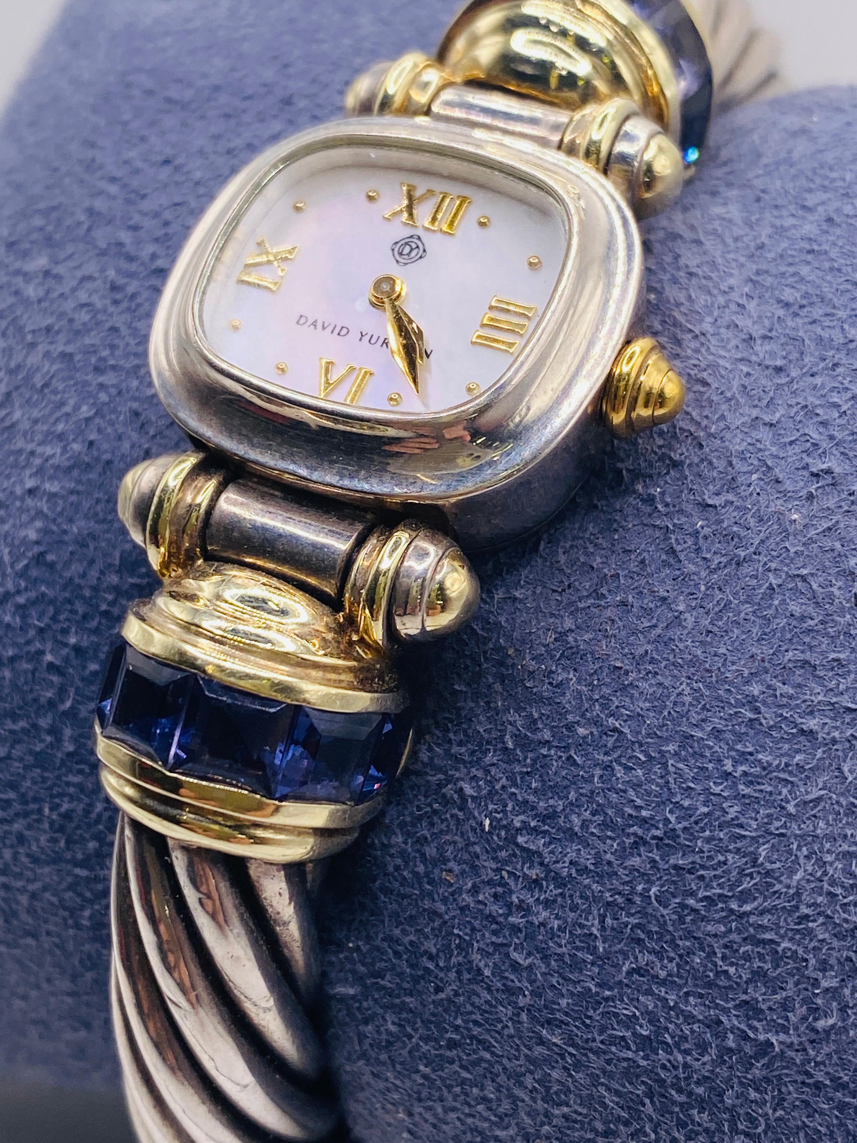 David Yurman cable cuff watch with 14k yellow gold, sterling silver and blue tanzanite stones. Item T-29004
