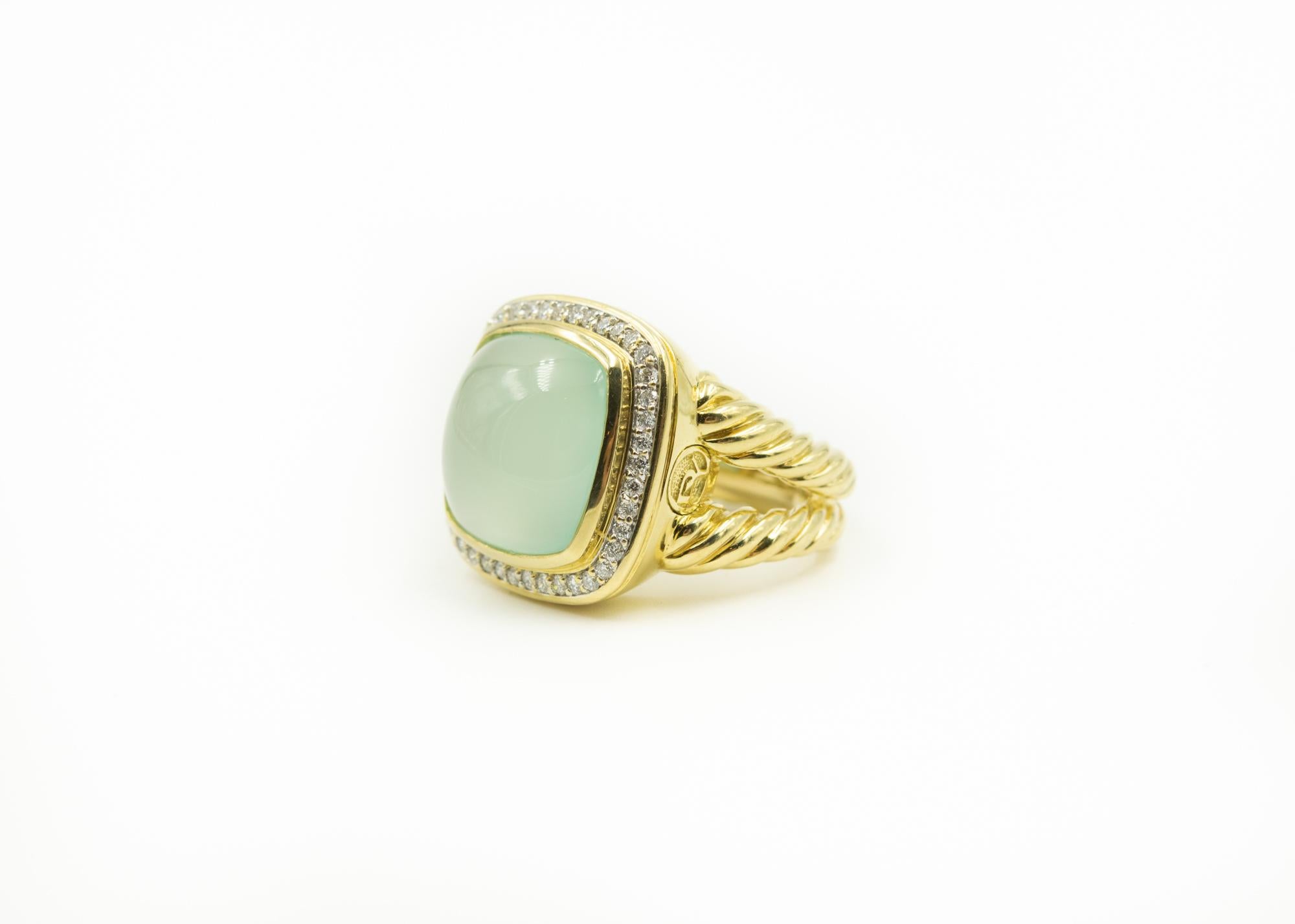18K yellow gold David Yurman Albion ring featuring cabochon aqua chalcedony with diamond halo and split cable textured shank.  Marked with DY logo on the outside side. Interior marks covered by ring sizer. 

Size 4.5