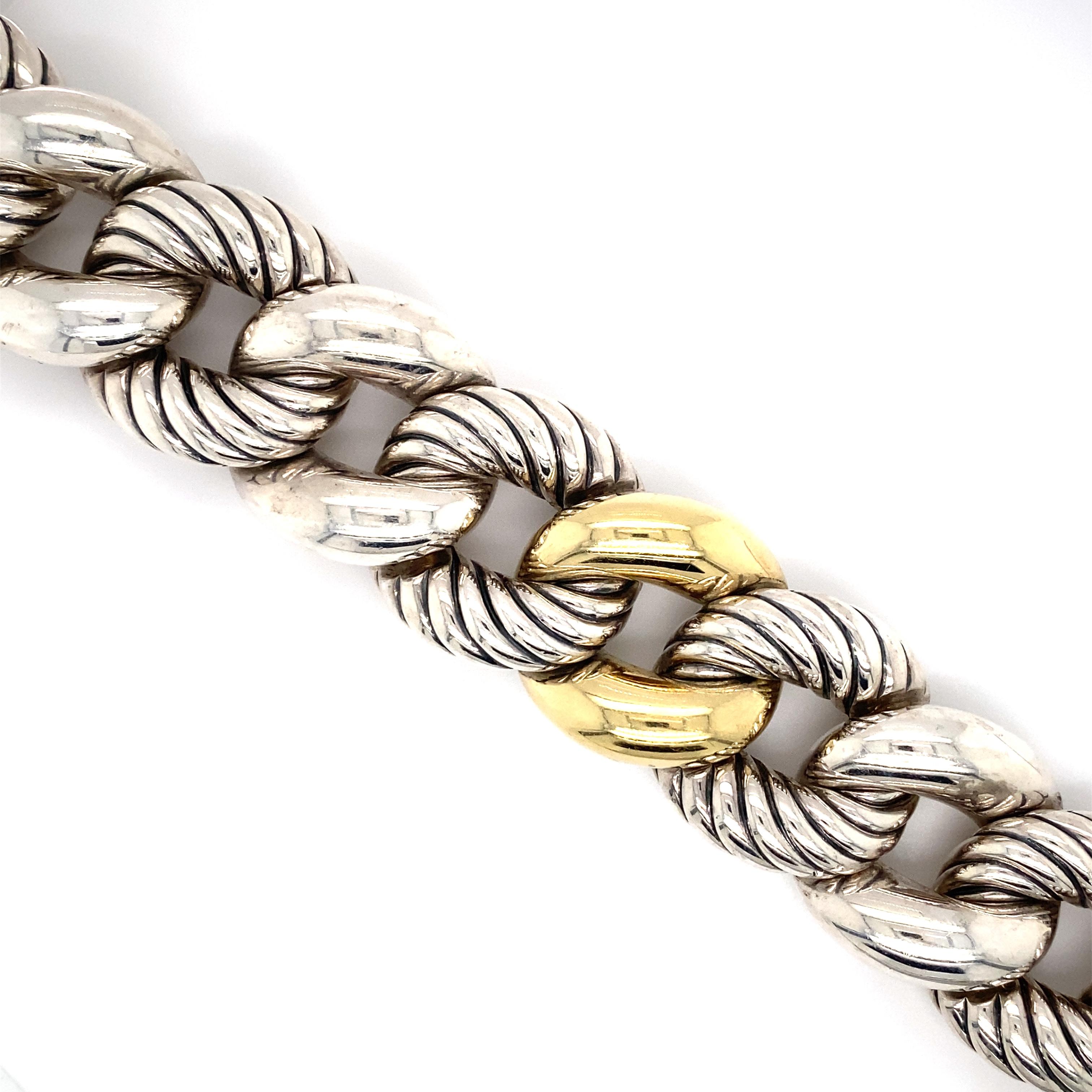 Item Details: This large curb link bracelet by David Yurman has 18k gold accents and is a great accessory to add as a statement!

Circa: 2000s
Metal Type: Sterling Silver and 18 Karat Yellow Gold
Dimensions: 8 inch Length x 1 inch Width