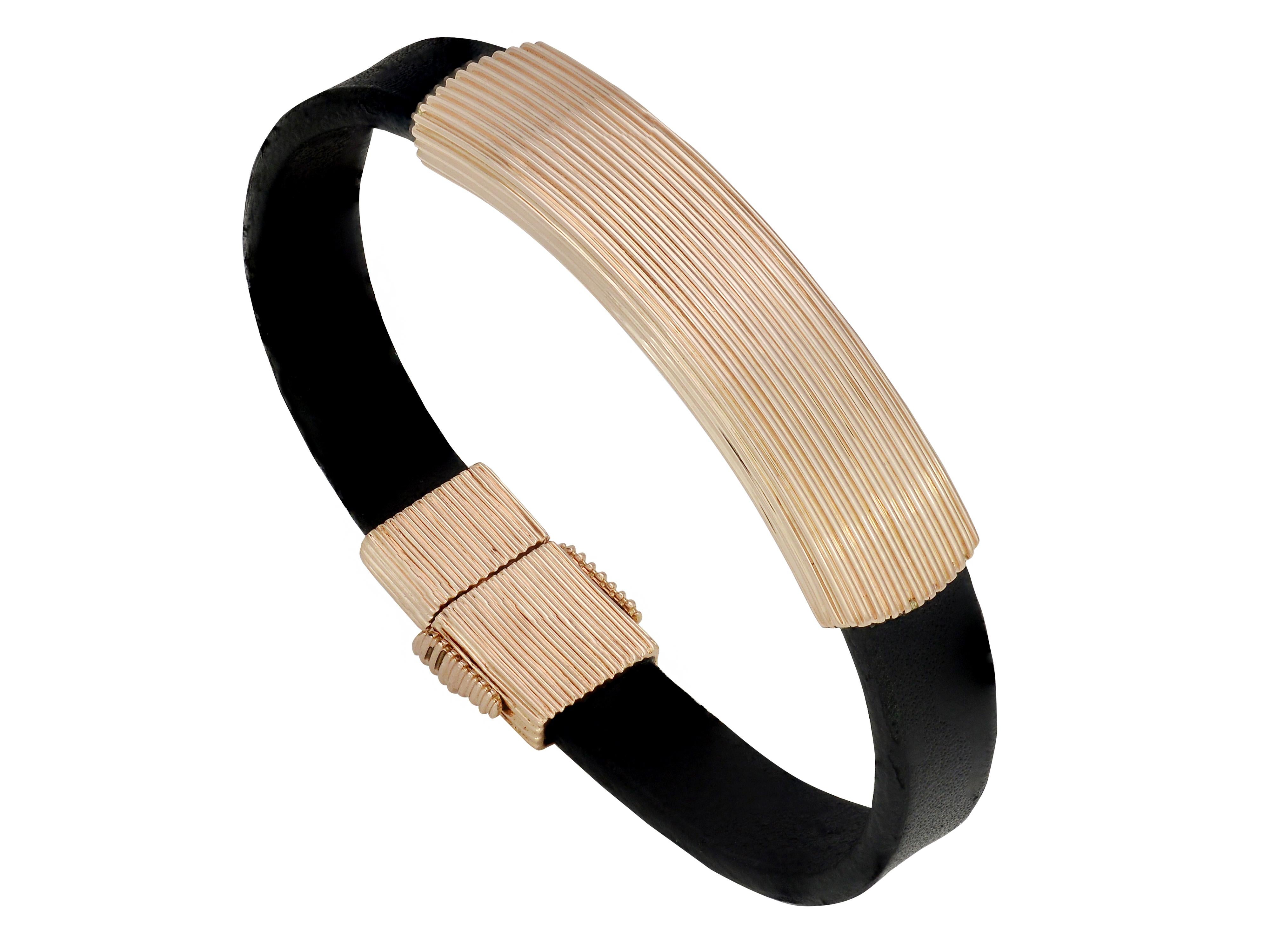 Men's Black Leather and Striated 18 Karat Rose Gold Bracelet From Designer David Yurman. Horizontal Line Design On Top and Outside of Clasp. Inside Is Stamped D. Yurman 750. Secure Clasp With Safety Lock. Weights 62 Grams. Original MSRP $9,000. 