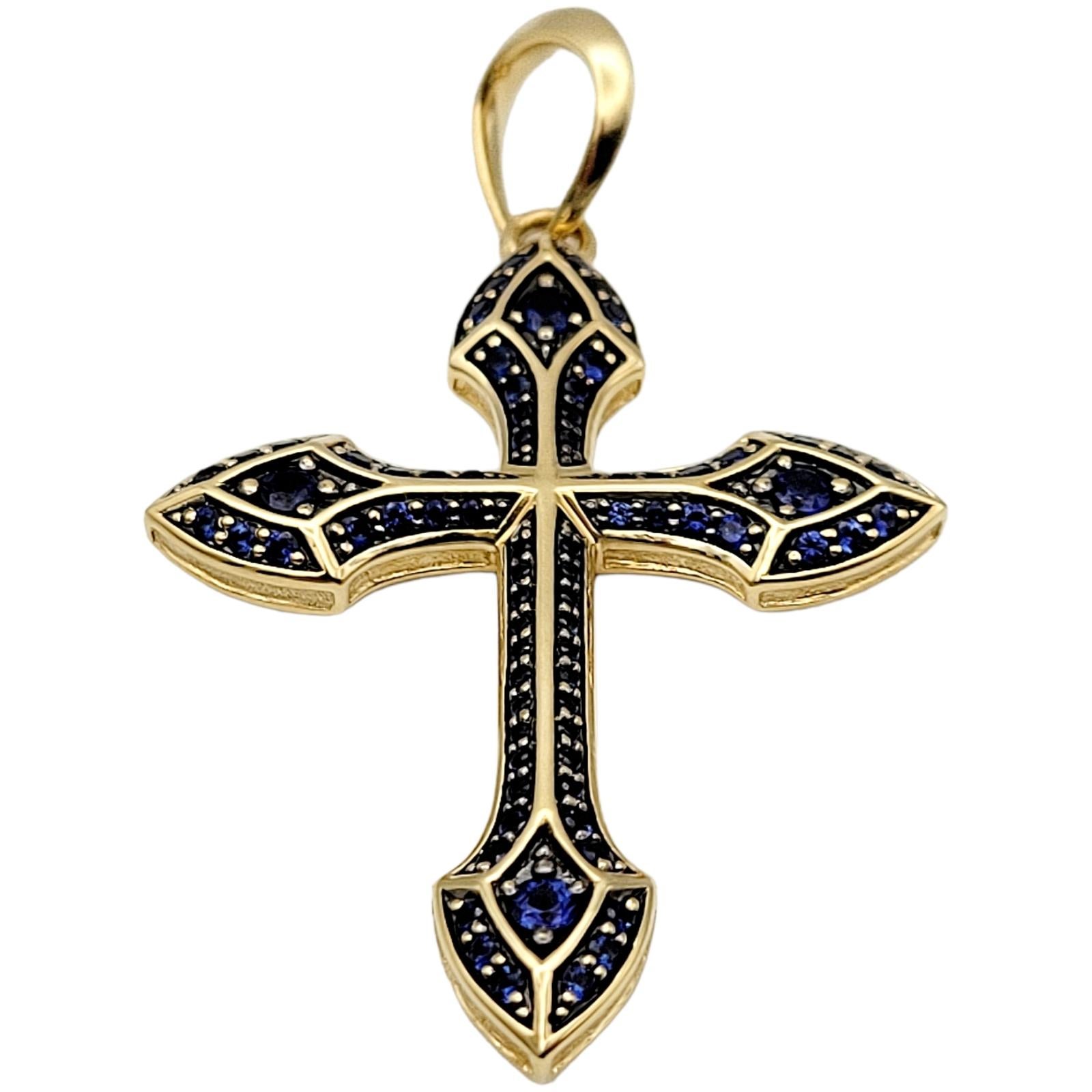 Introducing the alluring David Yurman Gothic Cross Amulet with Natural Sapphires in 18 Karat Yellow Gold. This exquisite piece combines spirituality and contemporary style, making it a true statement accessory for the modern man. Crafted by the