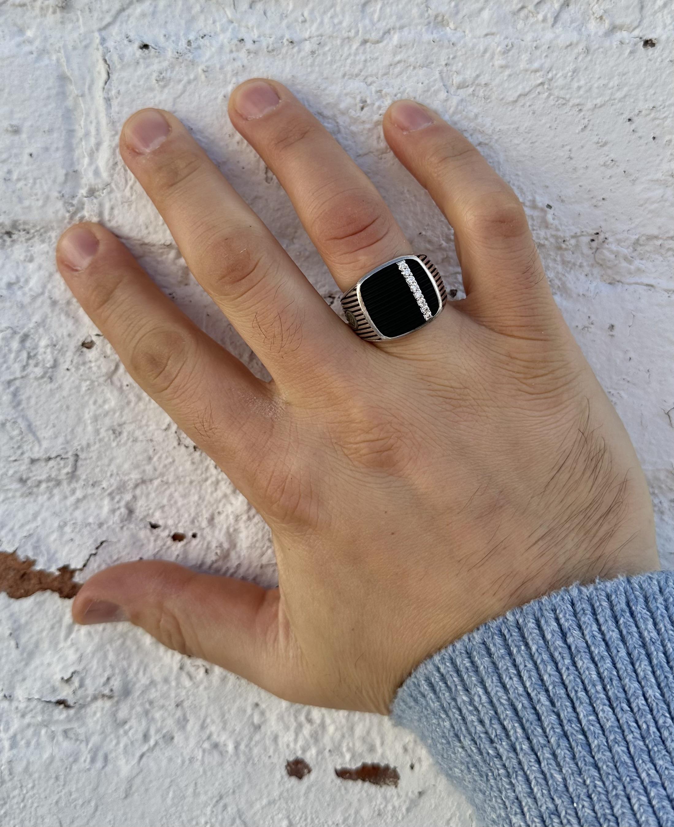 –Stone(s)–
(1) Natural Genuine Onyx - Grooved Banded - Custom Cut - Bezel Set - Black Color - 16.2 x 16.7mm (approx.)
(8) Natural Genuine Diamond - Round Brilliant Cut - Shared Prong Set - G/H Color - VS1/VS2 Clarity - 0.20ctw (approx.)

Material: