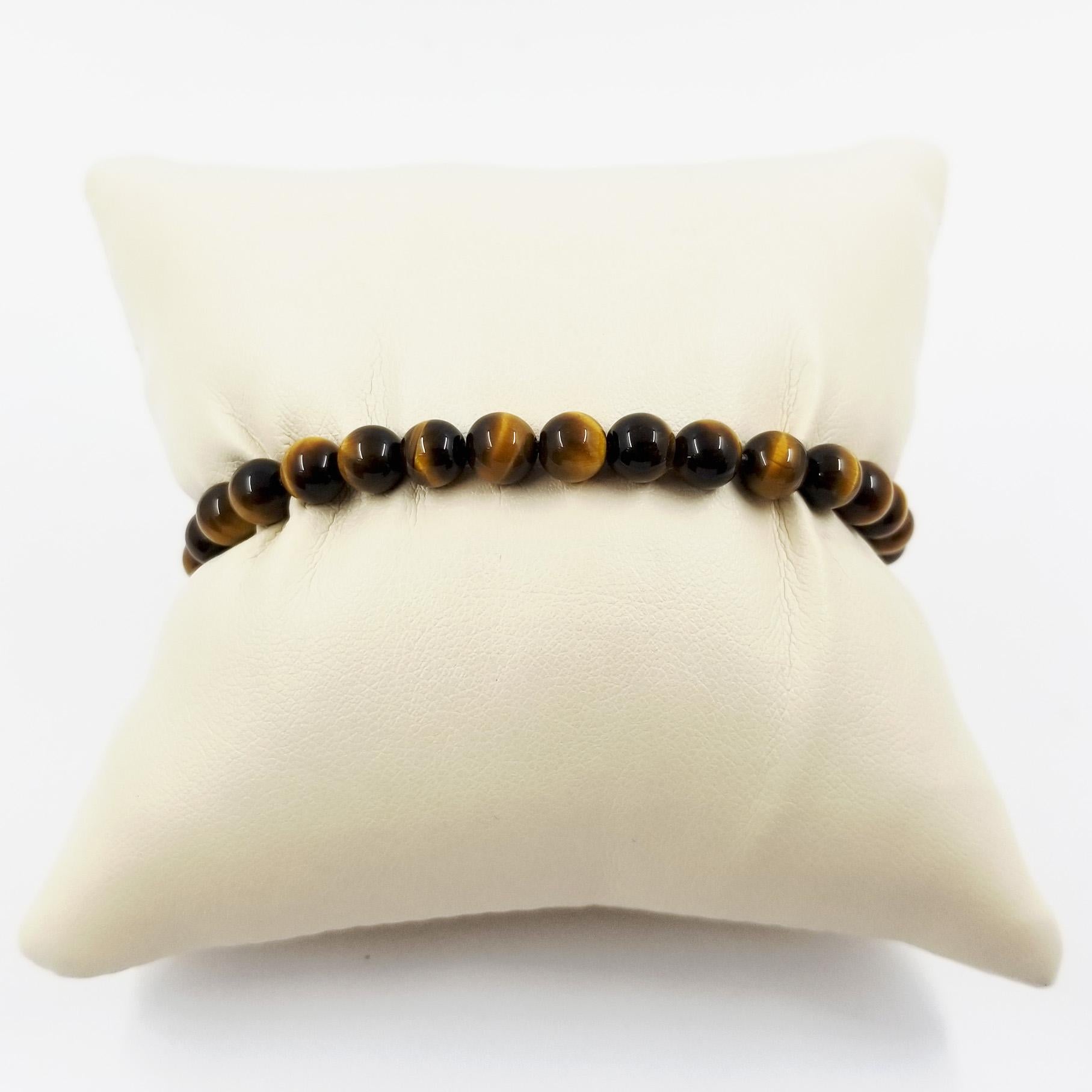 Sterling Silver and Tiger's Eye Men's Bead Bracelet, stamped 925 by designer David Yurman. The 6mm beads are strung on a flexible 8 inch long metal wire. The brushed finish clasp features a lobster mechanism. Original MSRP $295.