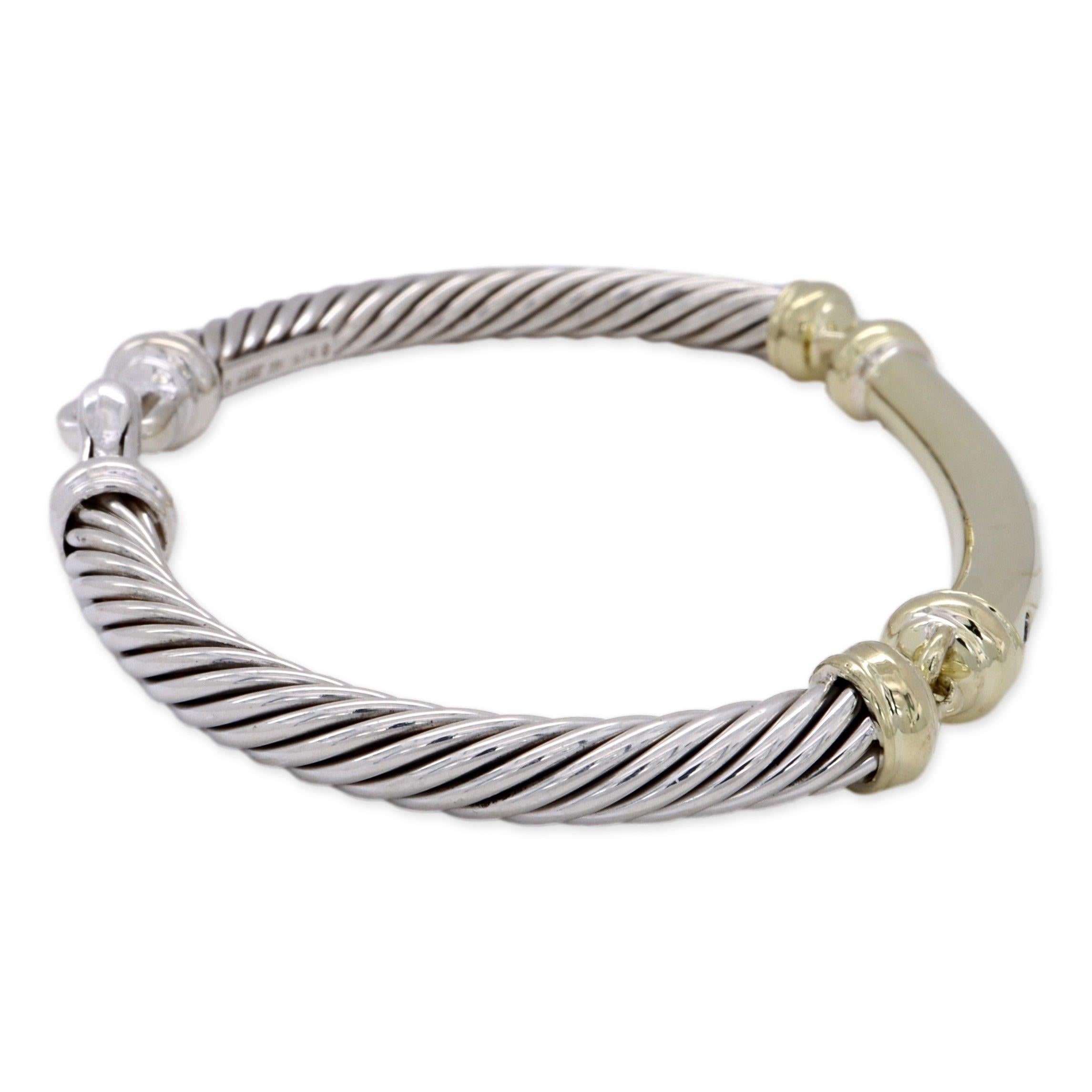 David Yurman two tone bracelet from the metro collection finely crafted in sterling silver in a cable twist design featuring a 14 karat yellow gold bar with 5 burnished set round brilliant cut diamonds weighing 0.15 cts approximately. The bracelet