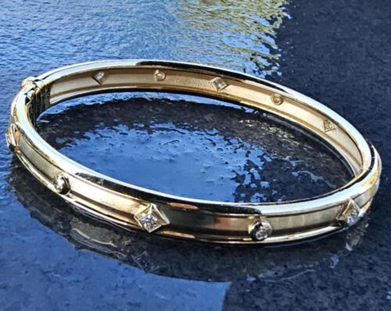 Add a touch of modern elegance to your jewelry collection with this stunning David Yurman bracelet bangle. Crafted from 18k yellow gold, this piece features a captivating diamond design that will elevate any outfit. The bangle style adds a unique