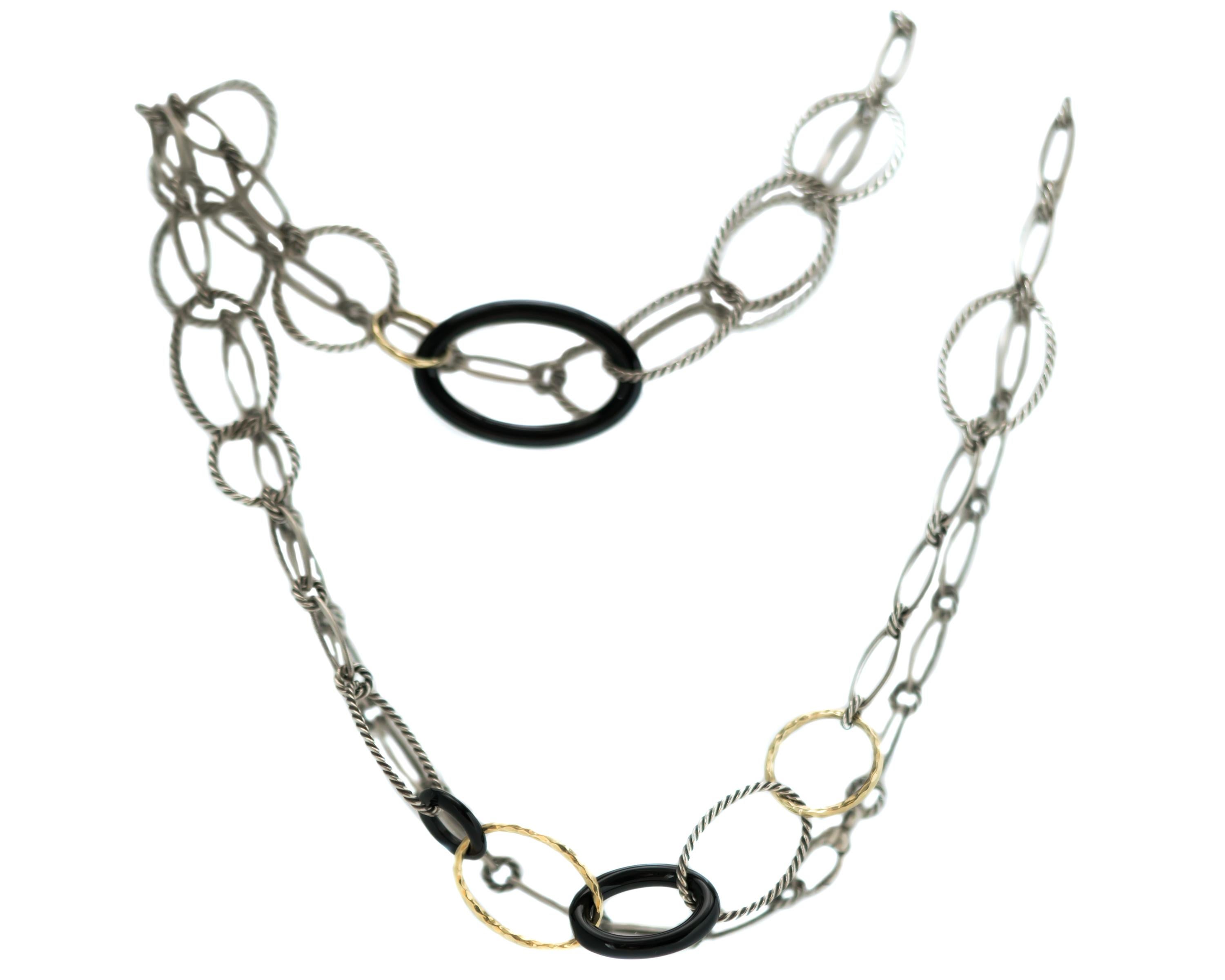 1980s David Yurman Link Necklace - Sterling Silver, 18 Karat Yellow Gold, Onyx

Features:
22 inches long
Round and Oval Links
Sterling Silver Smooth and Cable Links
18 Karat Yellow Gold Textured Links
Onyx Smooth Links
Can be worn as a long, single