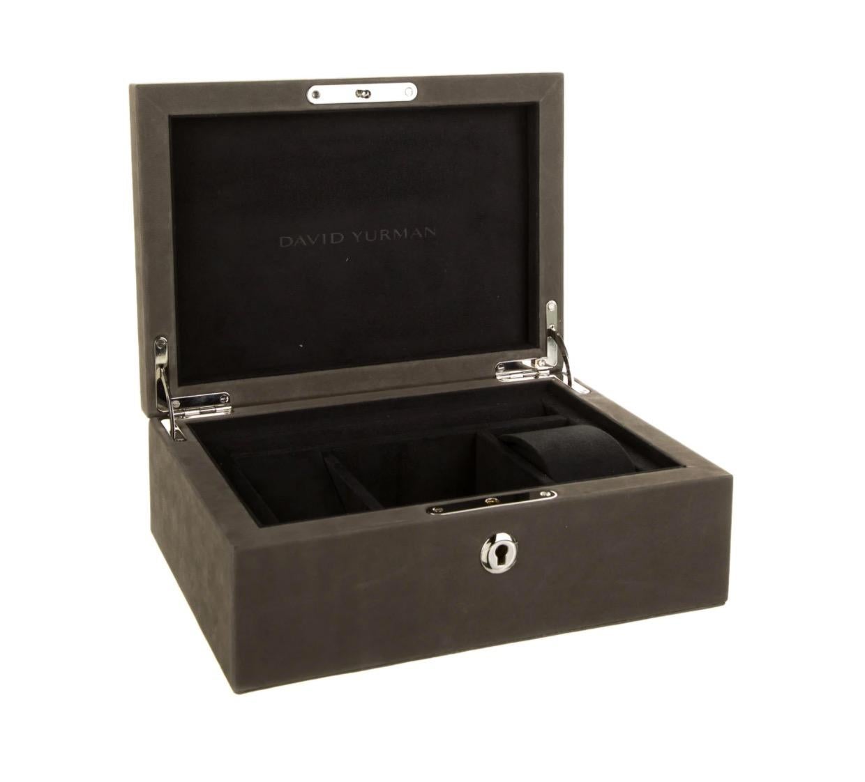 Suede 
Metal
Silver tone hardware 
Suede lining
Features four interior compartments
Measures 9.75