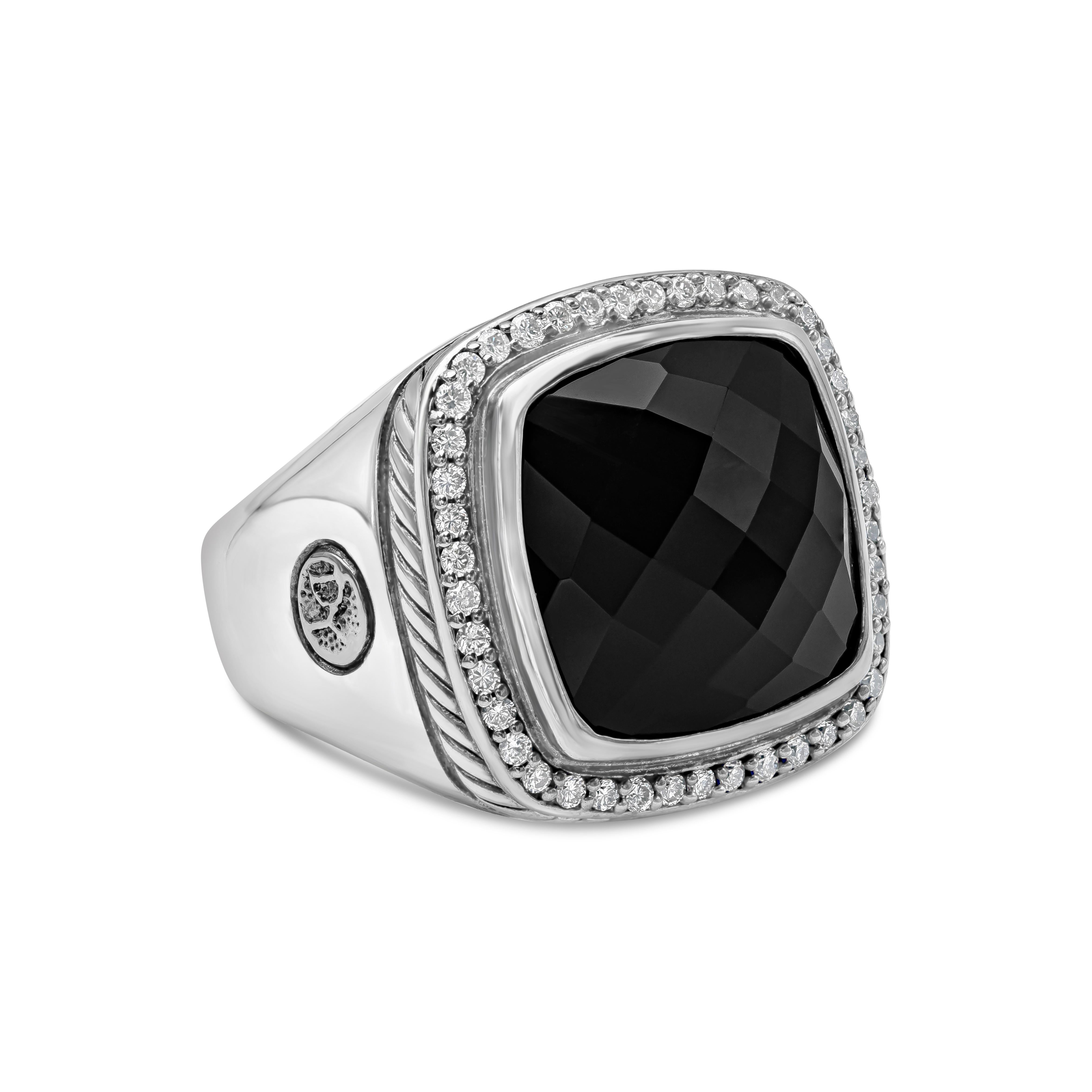 A beautiful and unique cocktail ring showcasing a large faceted black onyx, surrounded by a single row of round brilliant diamonds. Set in an intricately designed cocktail band made in sterling silver. Made and signed by David Yurman. 