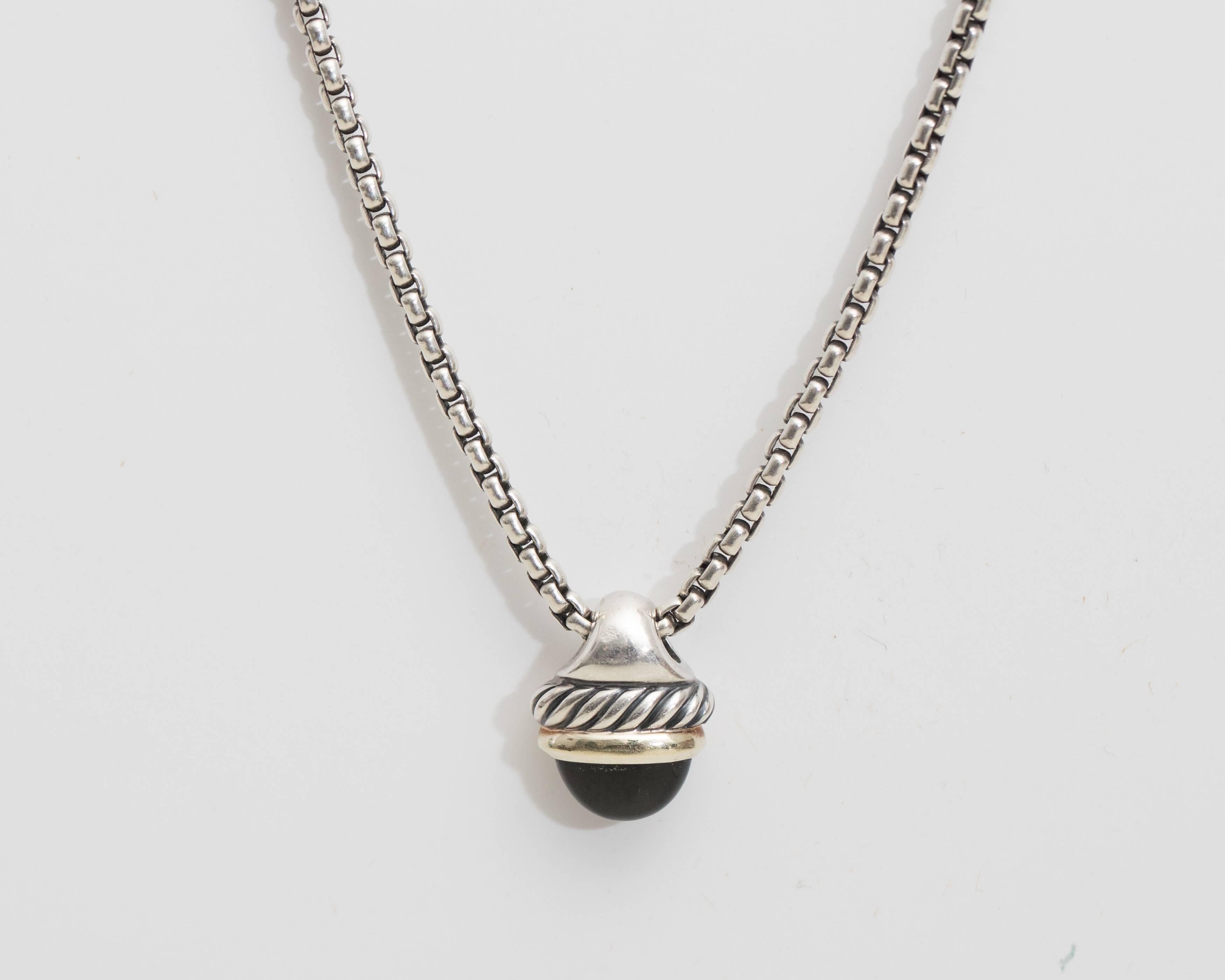 David Yurman Cable Pendant Necklace - Sterling Silver, 18 Karat Yellow Gold, Onyx

Features a rounded Box Chain, two tone Pendant with Classic Cable design and Black Onyx Cabochon. The pendant has a broad Sterling Silver bail supported by a Sterling