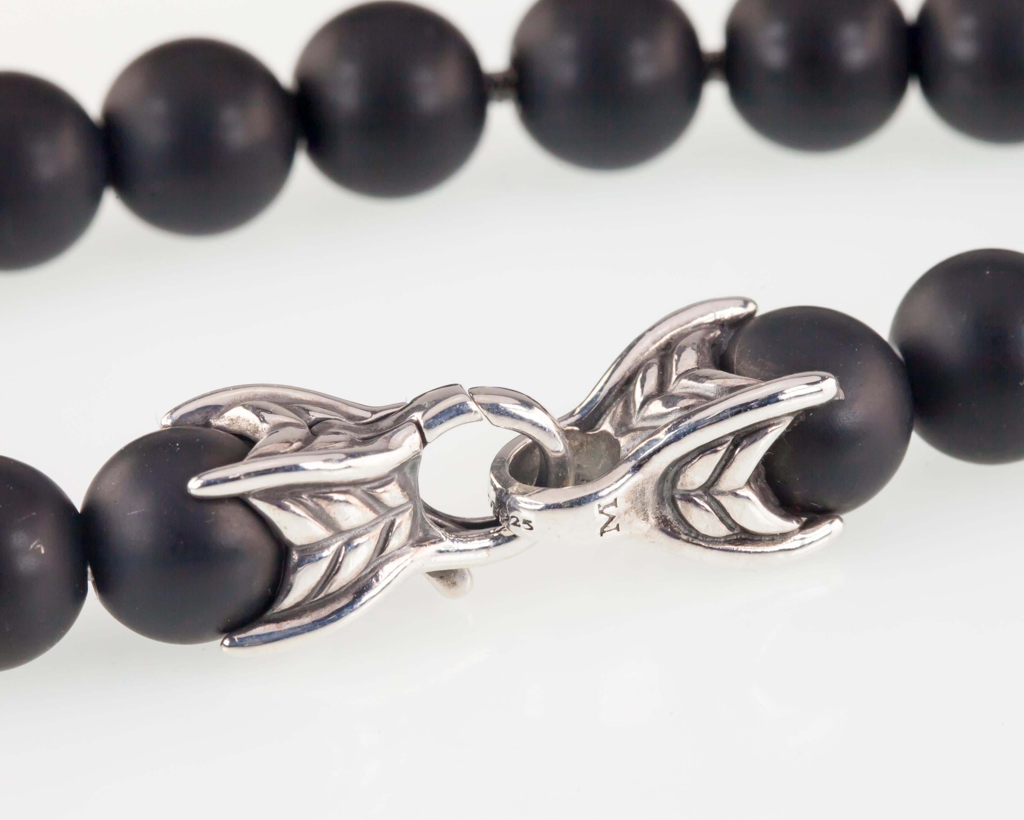 Gorgeous Onyx Spiritual Bead Bracelet by David Yurman
Features Unique Sterling Silver Clasp and Chain
Includes Single Black Diamond Pave Bead w/ 0.63 cts Diamonds
Total Length = 8.25