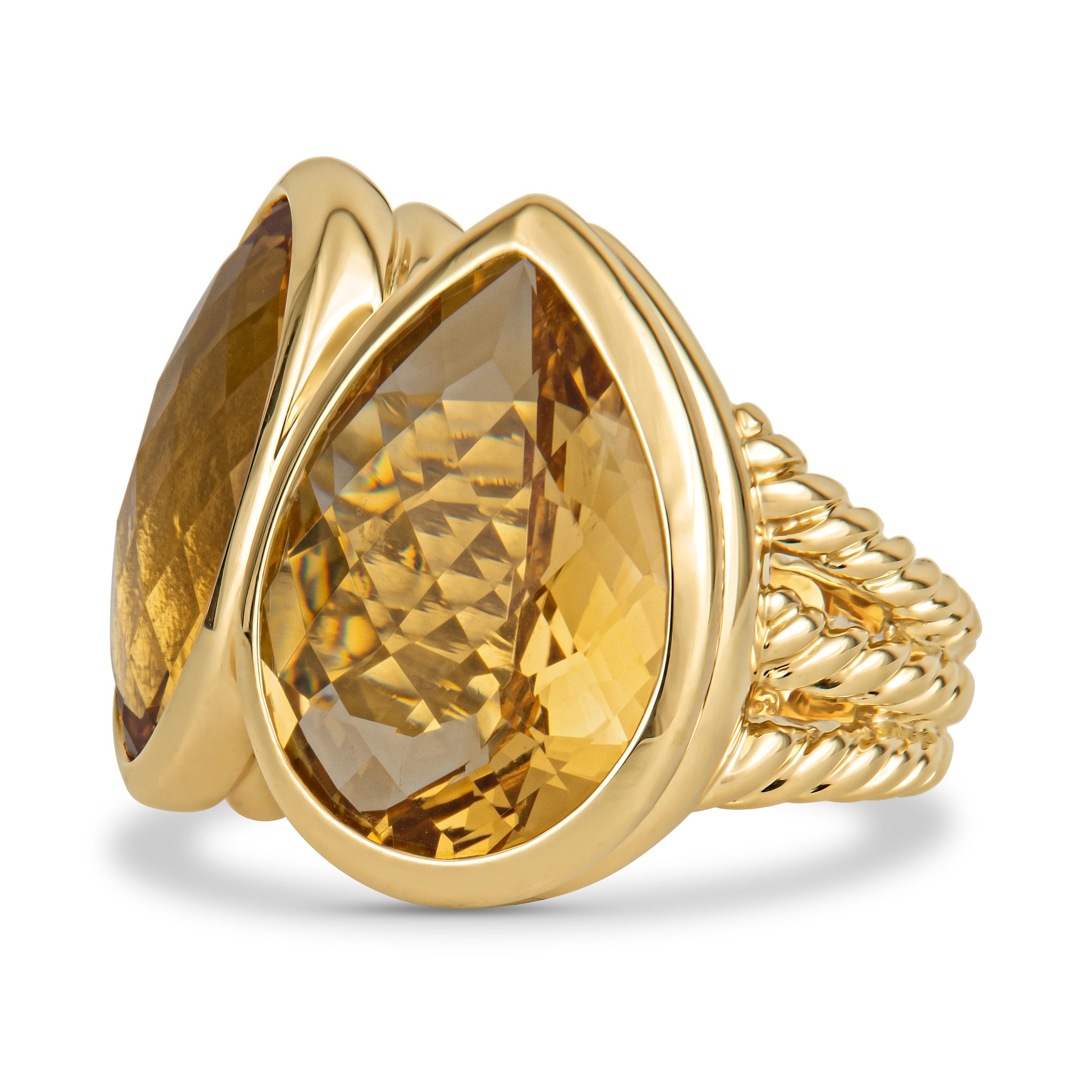 This unique ring is a David Yurman piece, with its classic three-row rope band and cutting style of the citrine stones. The stones sit side by side, with one oval and one pear shape citrine stone. The ring itself is 18kt yellow gold, in a size 6. It