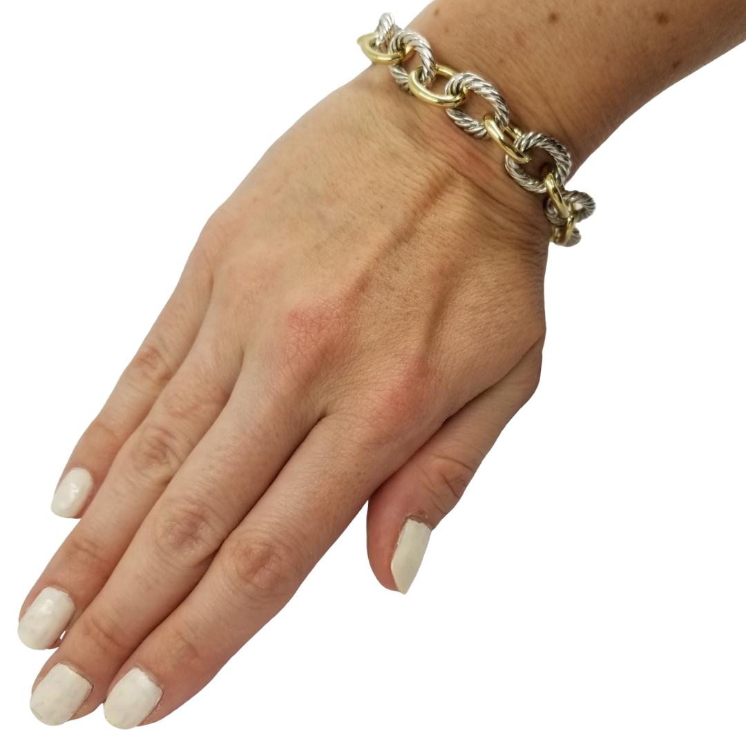 David Yurman Sterling Silver & 18 Karat Yellow Gold Oval Link Bracelet. Original MSRP $1,700. 7.5 Inches Long. Professionally Polished To Remove Scratches. Comes with Yurman Pouch & Polishing Cloth.