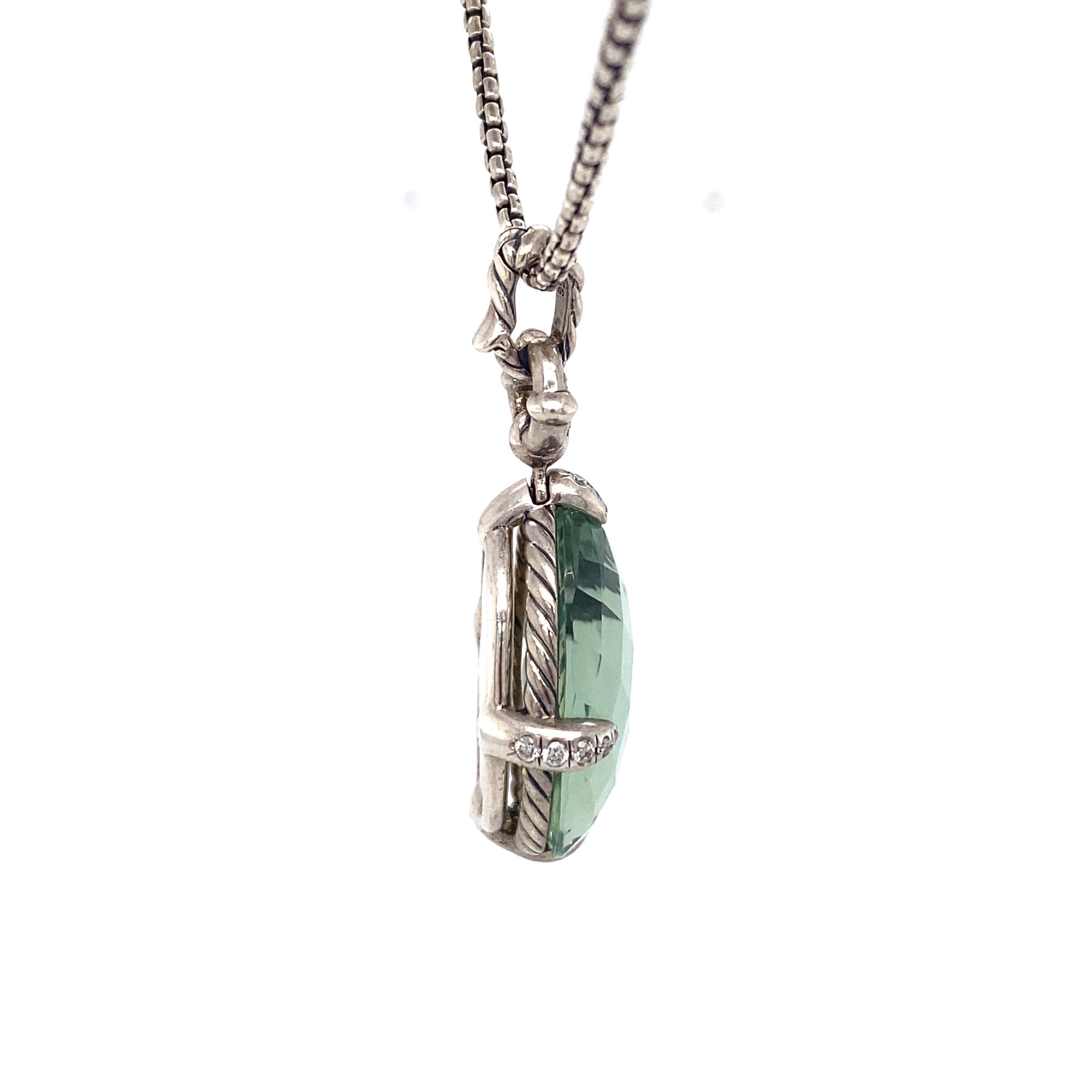 This pendant by David Yurman features an oval prasolite stone with accent diamonds on an adjustable chain that extends to 38 inches.

Circa: 2000s
Metal Type: Sterling silver
Weight: 25.2g
Dimensions: Chain extends to 38 inches