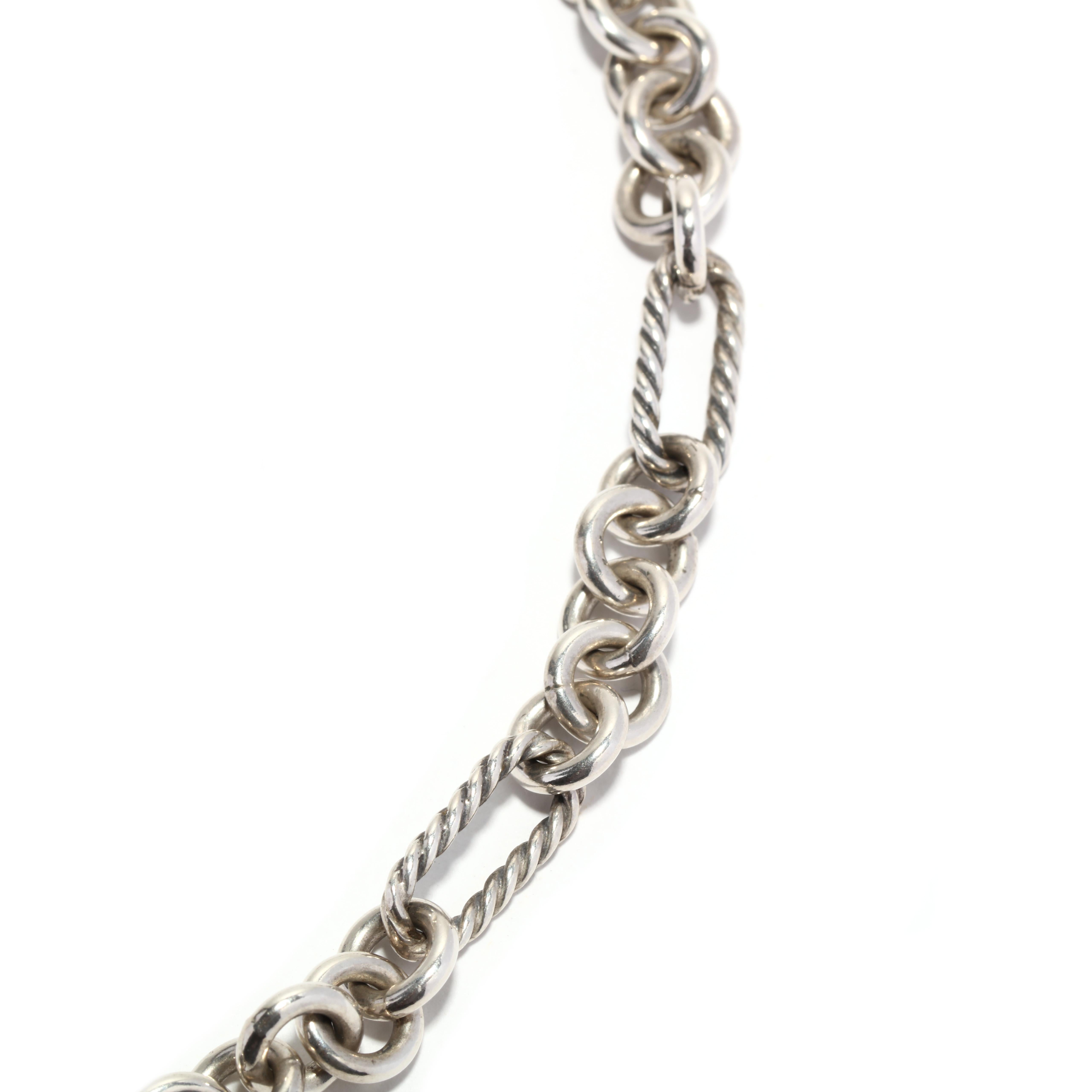 This David Yurman oval round link toggle chain necklace is a luxurious and elegant piece that will add a touch of sophistication to any outfit. Made with 18K yellow gold and sterling silver, this necklace is perfect for those who love the