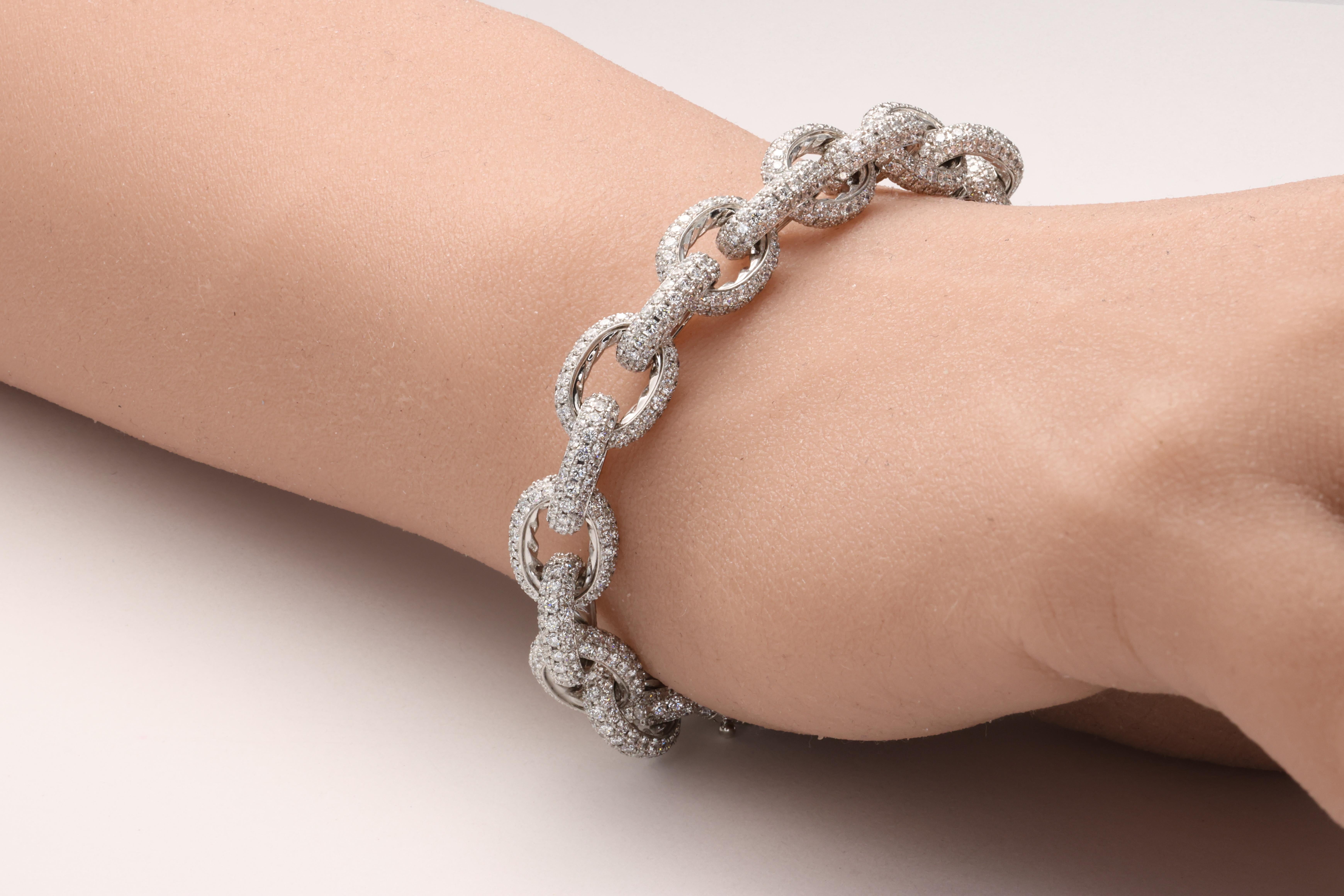 This outstanding bracelet finely crafted by David Yurman in 18 karat white gold is pave set with approximately 13.50 carats of fine quality E-G color VVS-VS clarity round brilliant cut diamonds in 3 rows covering the entire circumference of each