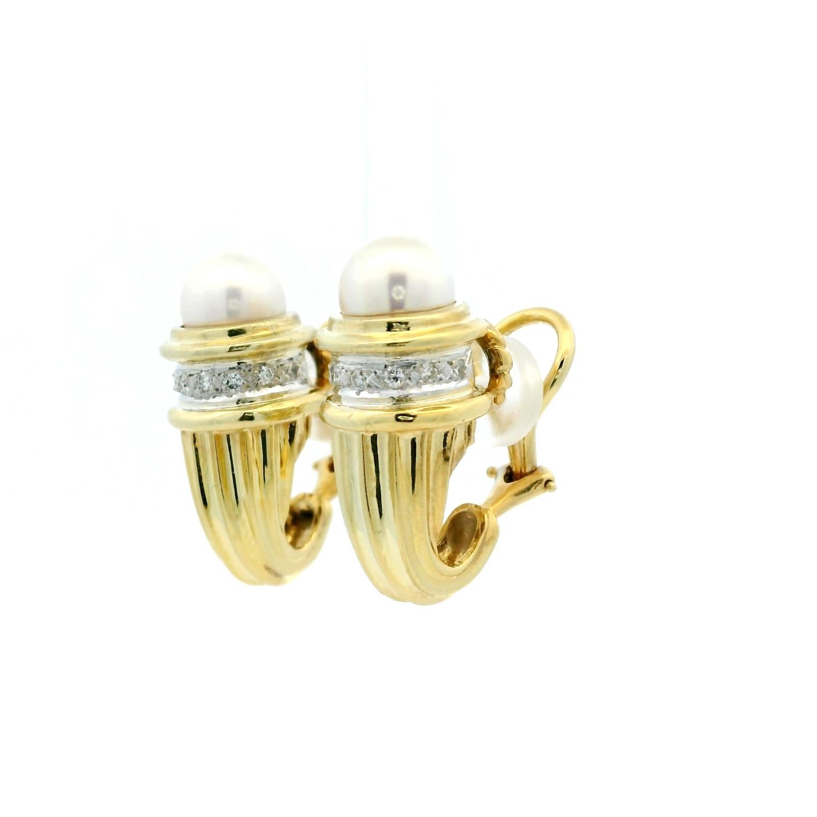 A pair of David Yurman pearl and diamond clip earrings in 14 karat yellow and white gold. 

These yellow gold clip earrings are detailed with David Yurman's distinctive deeply engraved finish tapering up towards the top of the ear lobe where a strip
