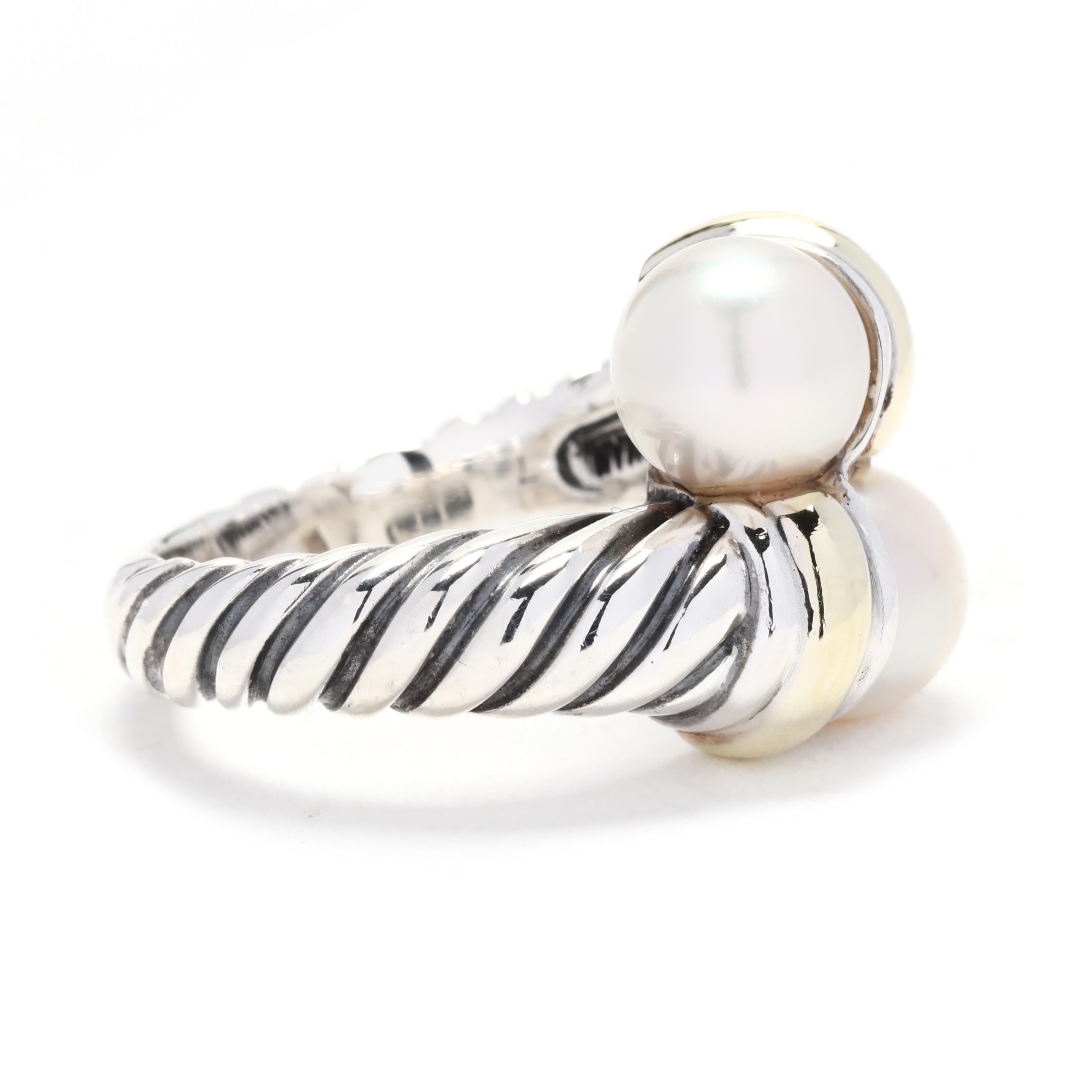 This David Yurman Cable Classics Two Pearl Crossover Ring is a stunning and elegant piece of jewelry. Made with 14K yellow gold and sterling silver, this ring features two beautiful pearls that crossover each other in a unique and eye-catching