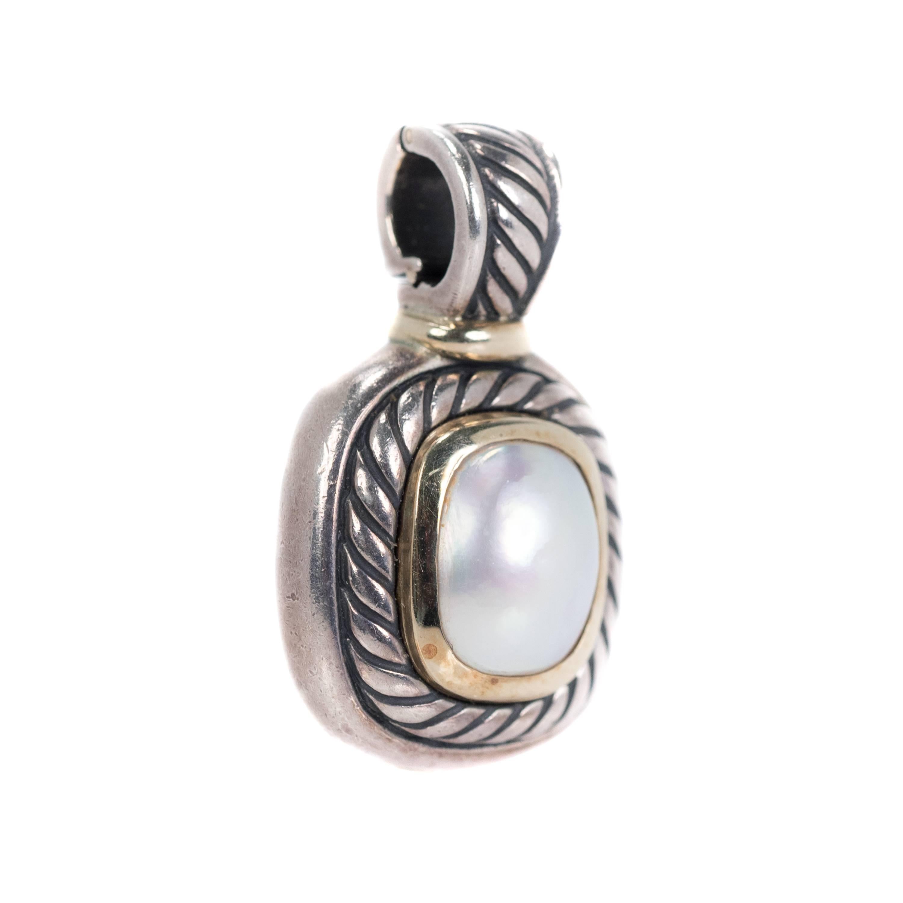 David Yurman Pearl Pendant - Sterling Silver, 14k Yellow Gold, Pearl

Features a large Oval Pearl in a rectangular two tone cable frame. 
The silvery white, rainbow lustre Pearl cabochon is securely set in a 14k Yellow Gold bezel frame. The gold is