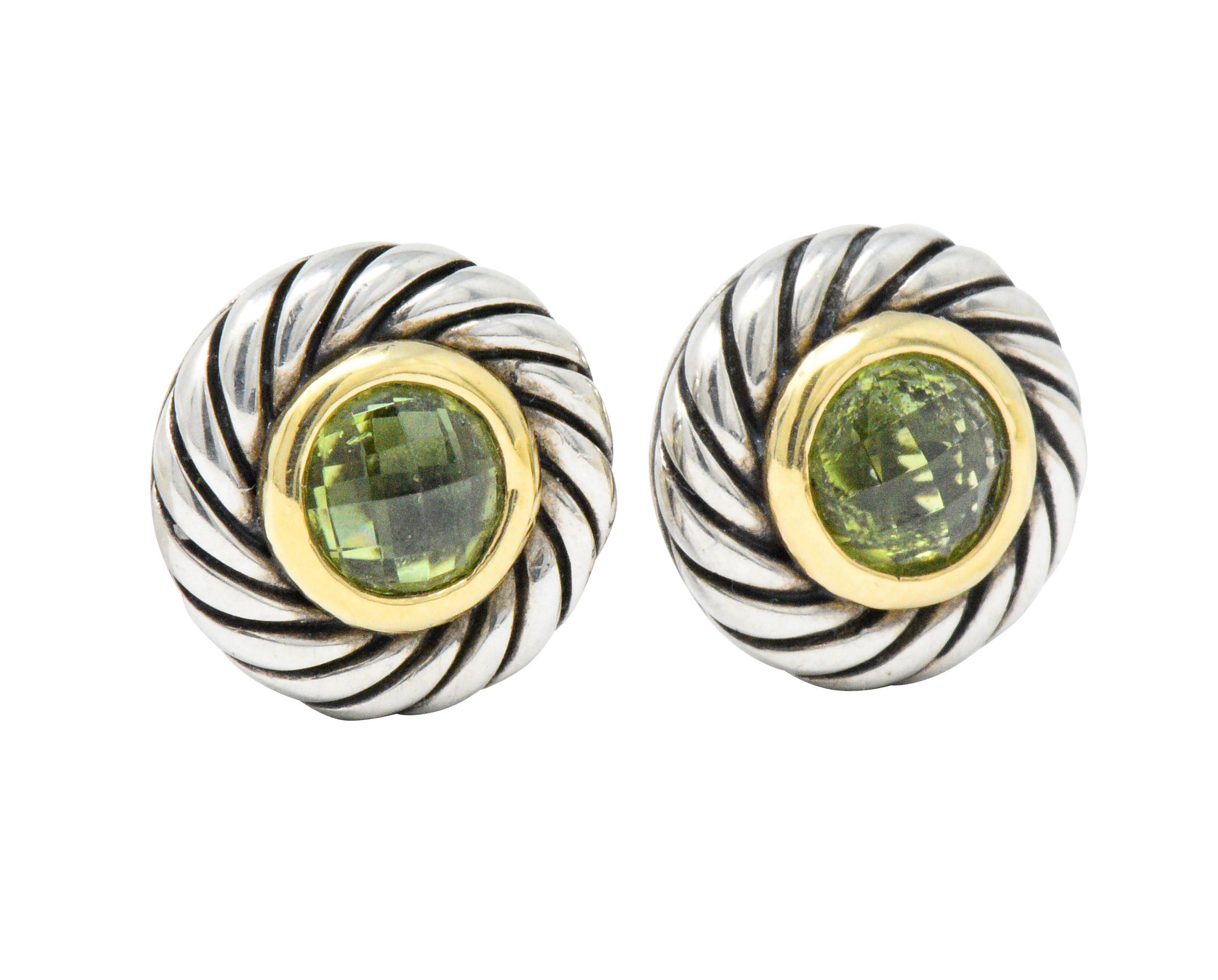 Featuring a round sterling silver foundation with classic cable twist motif along the outer edge

With an 18k gold ring and bezel set faceted round peridot in the center

Cookie Earring with oversized back for post

Signed DY 750 925

Measuring 14