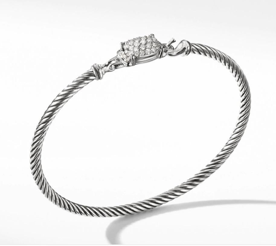 Inspired by the fluid rhythm and graceful line of unharvested wheat, the Wheaton Collection illuminates slender strands of David Yurman’s signature Cable motif with brilliant pavé diamonds.

-Sterling Silver
-Pavé Diamonds, 0.37 total carat