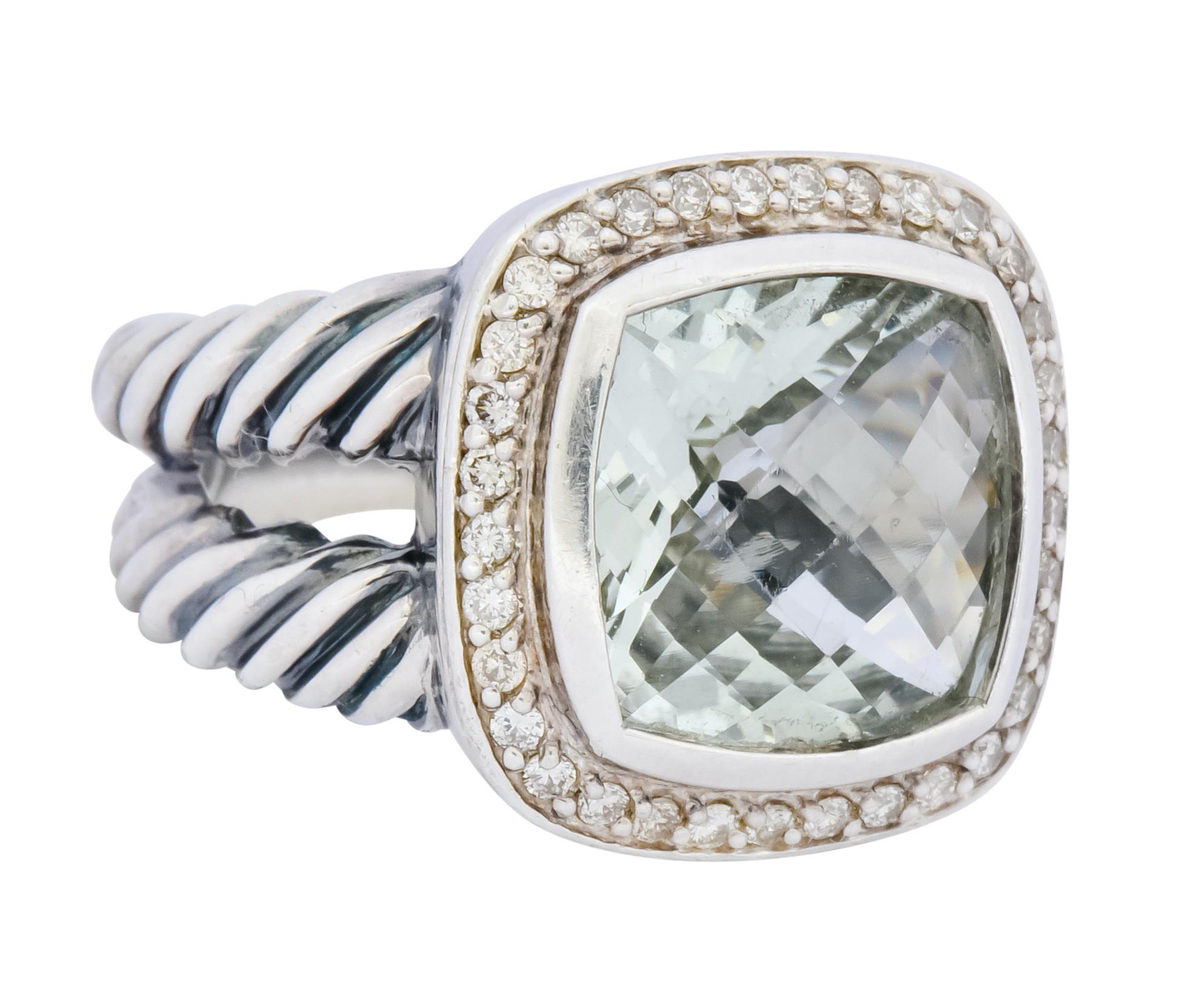 Centering a checkerboard cushion cut prasiolite measuring approximately 11.0 mm, transparent and a very light sea foam green color

Bezel set with round brilliant cut diamond surround that weighs approximately 0.33 carat total, eye-clean and